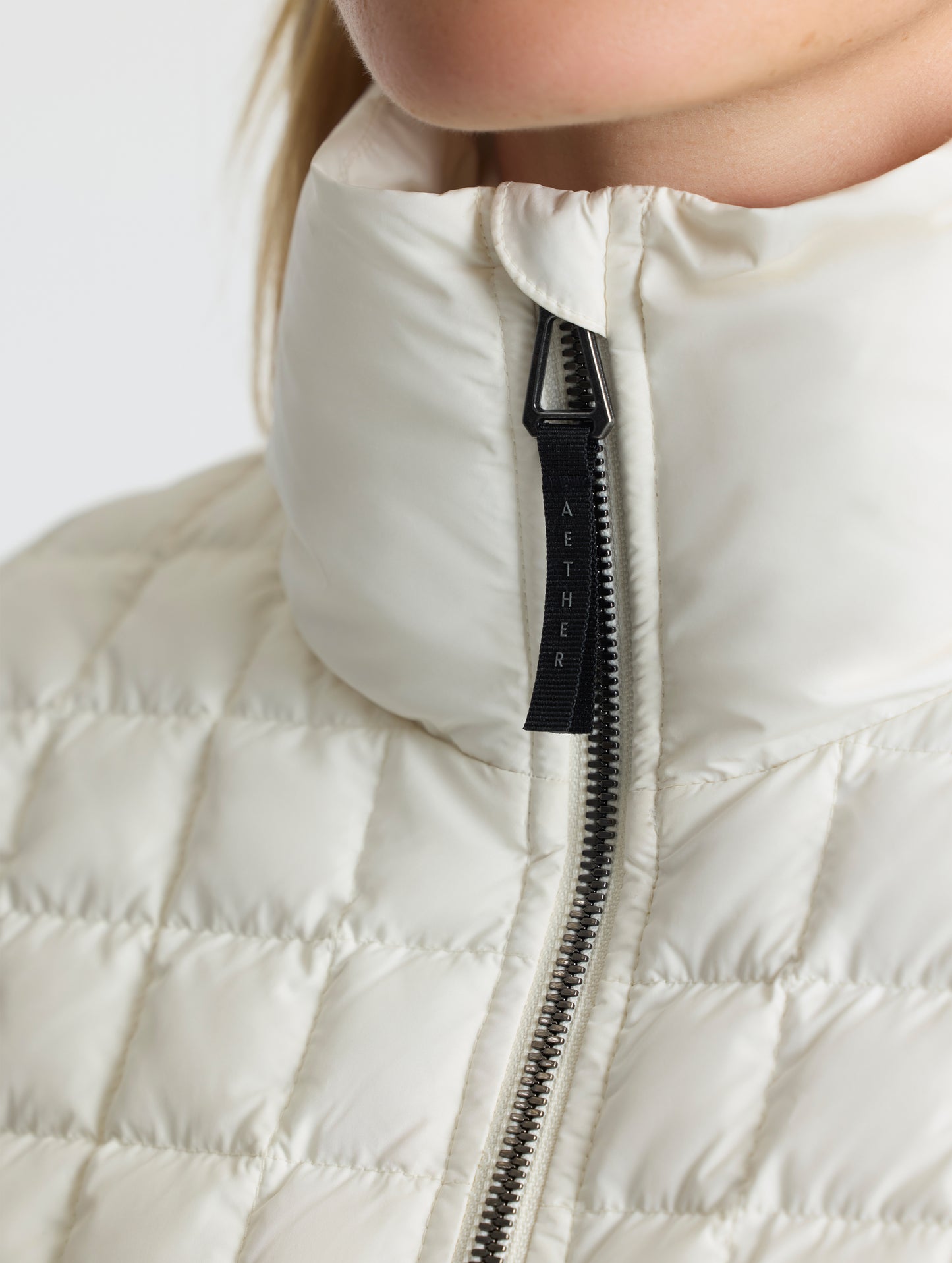 Closeup detailed view of the quilted body and insulated exterior collar on the Phase Full-Zip in Winter White from AETHER Apparel.