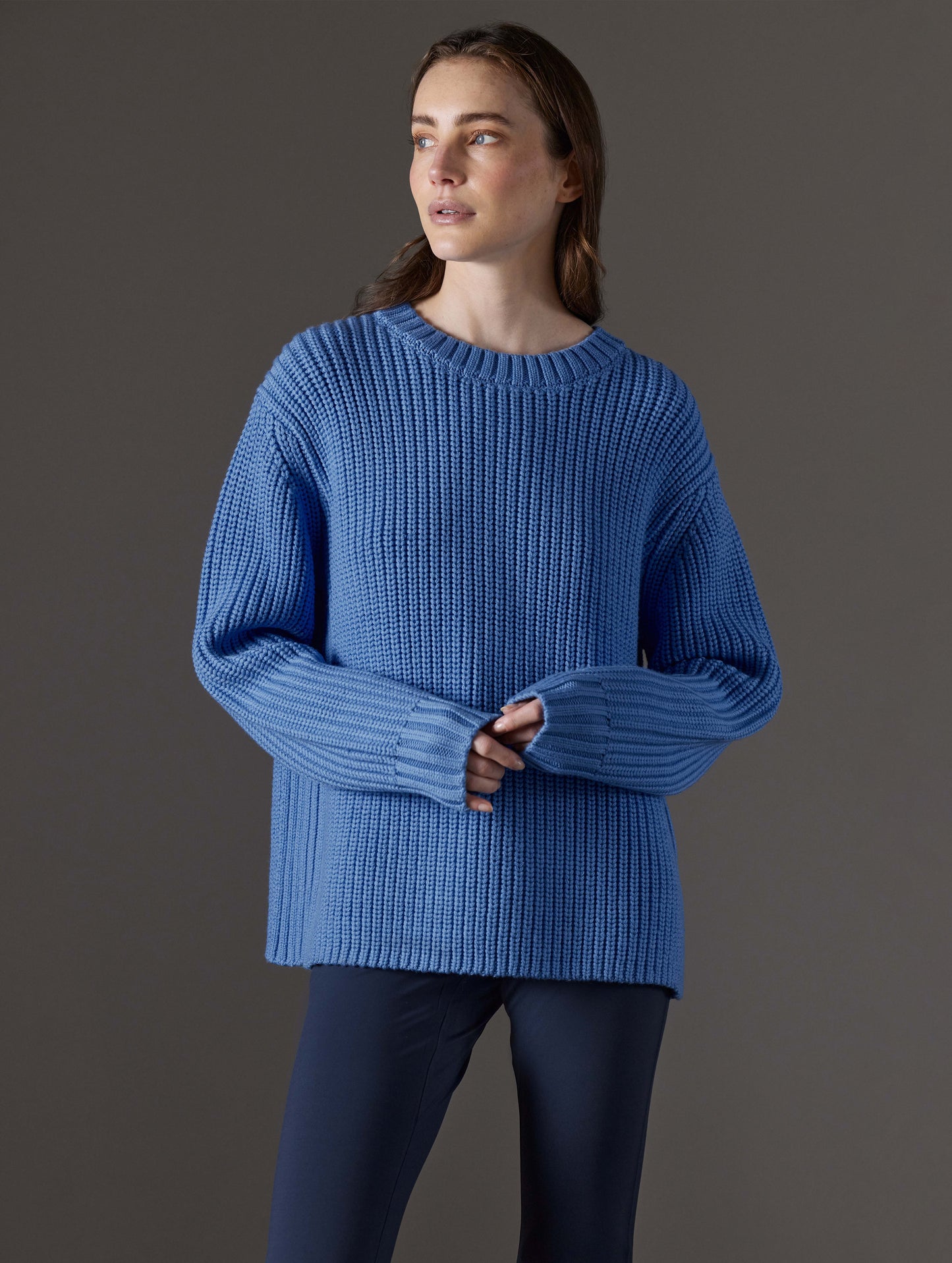 Front angled view of woman wearing Sherwood Crewneck Sweater in Lavender Blue from AETHER Apparel.