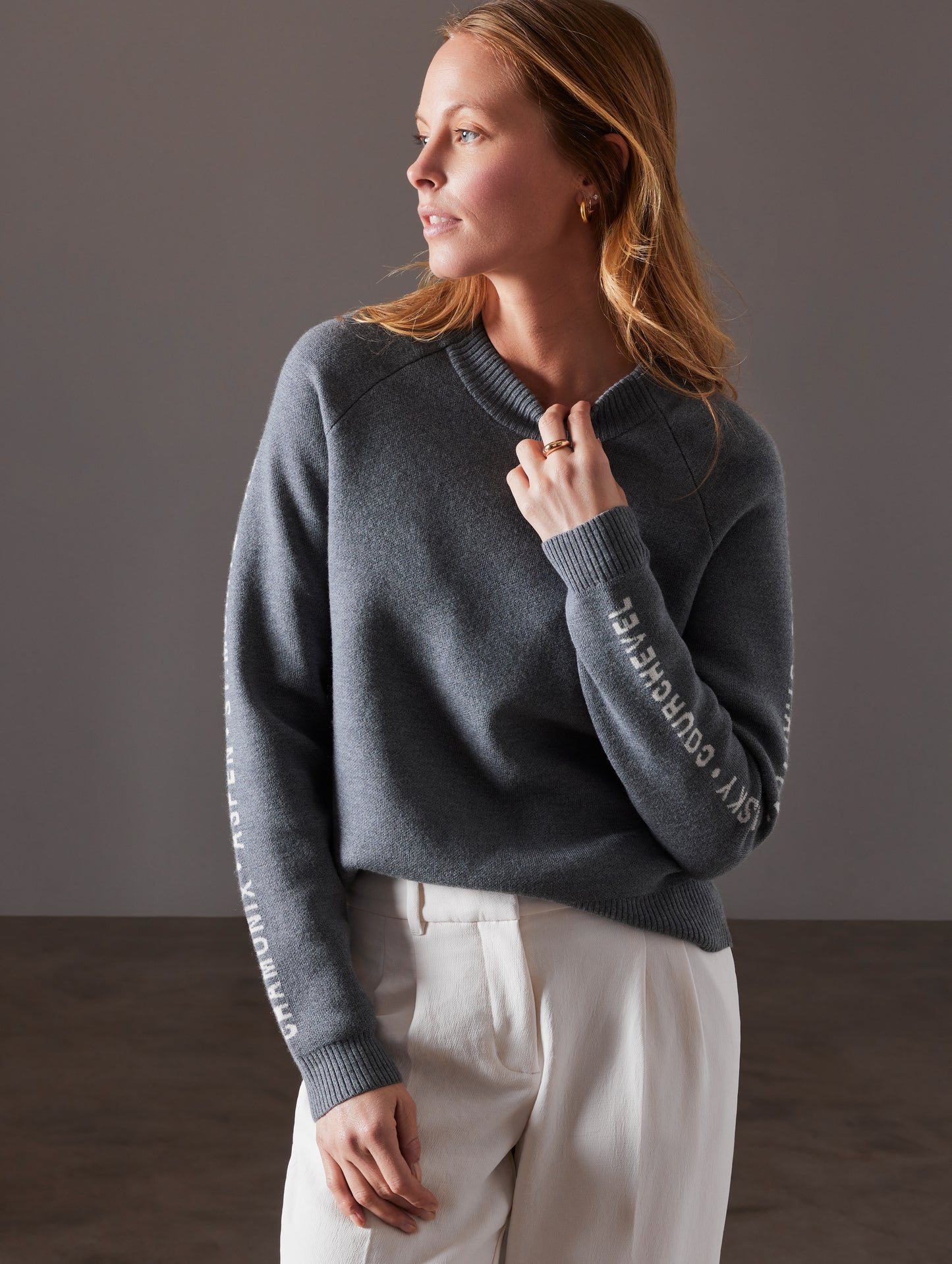 Front view of woman wearing Ski Town Sweater in Heather Grey from AETHER Apparel.