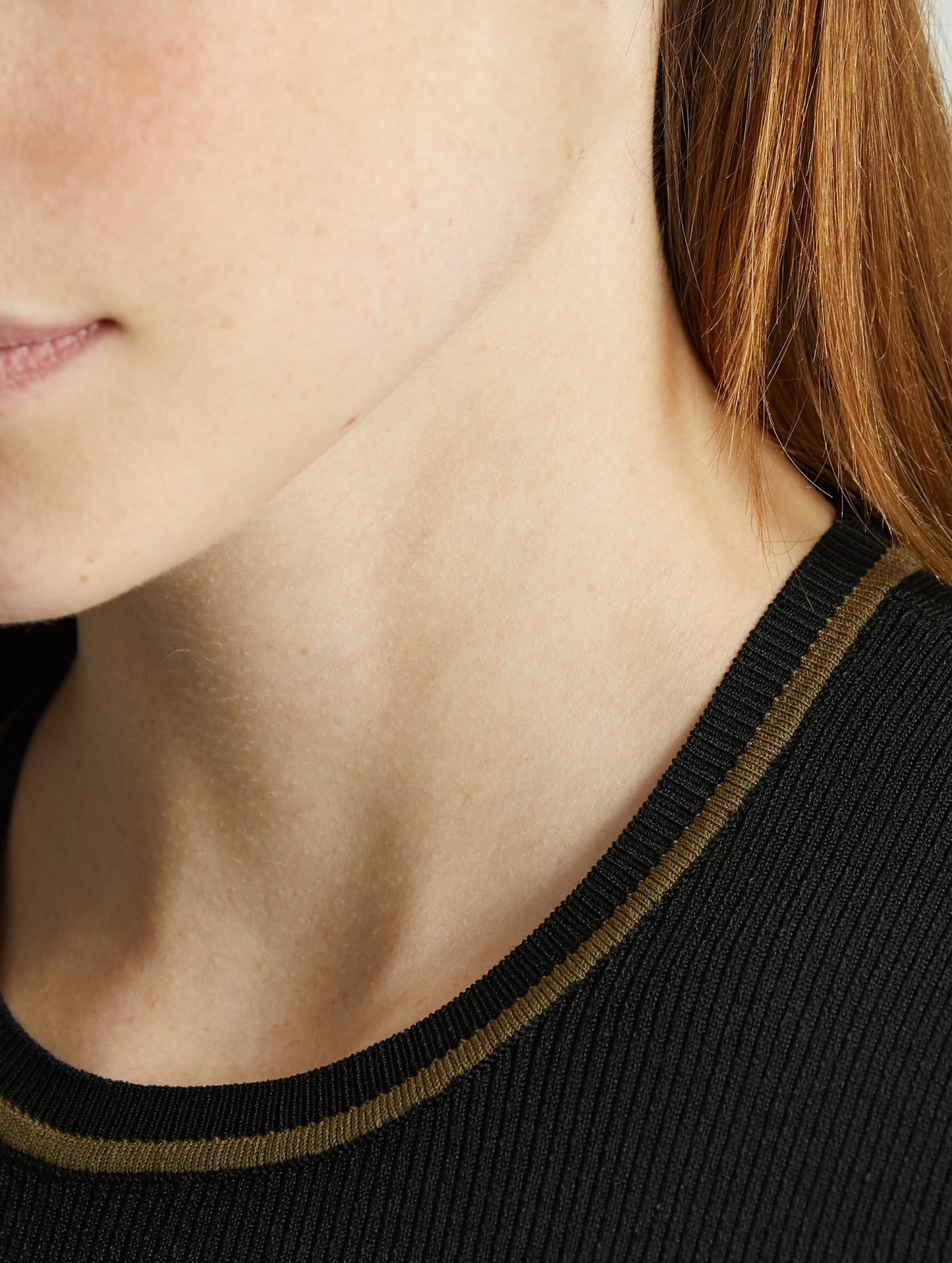 Woman wearing blue Short-Sleeve Rib-Knit Crew Sweater from AETHER Apparel, with collar detail in close view.
