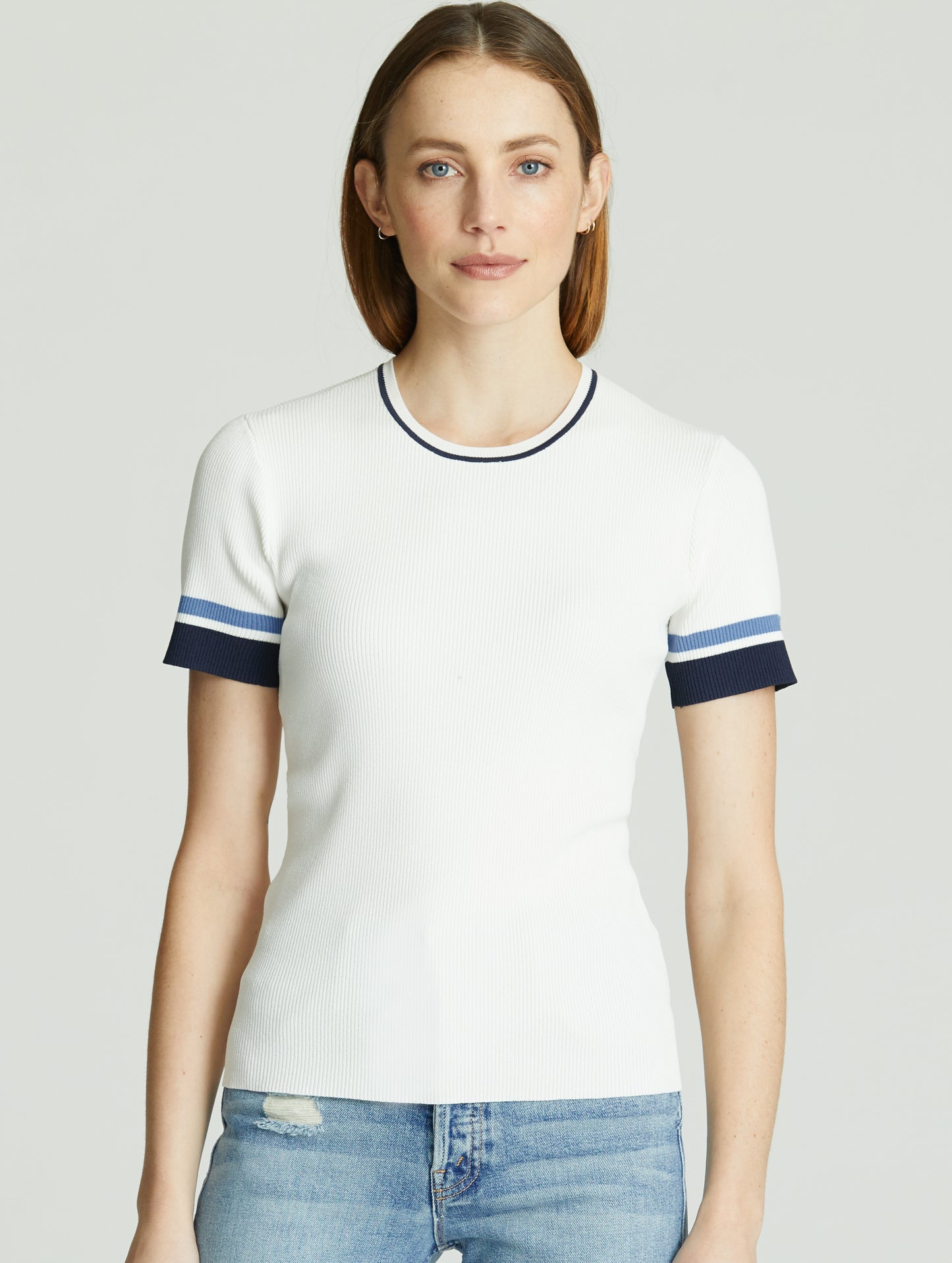 Front, upper body view of woman wearing white Short-Sleeve Rib-Knit Crew Sweater from AETHER Apparel.