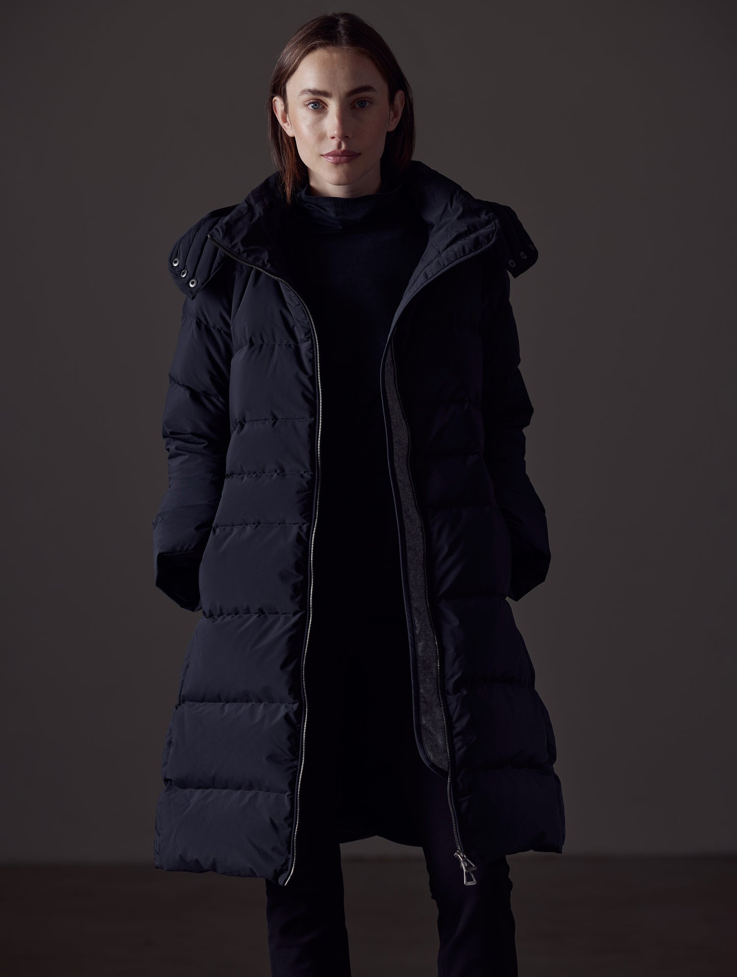Front view of woman wearing Stirling Jacket in Onyx Black from AETHER Apparel.