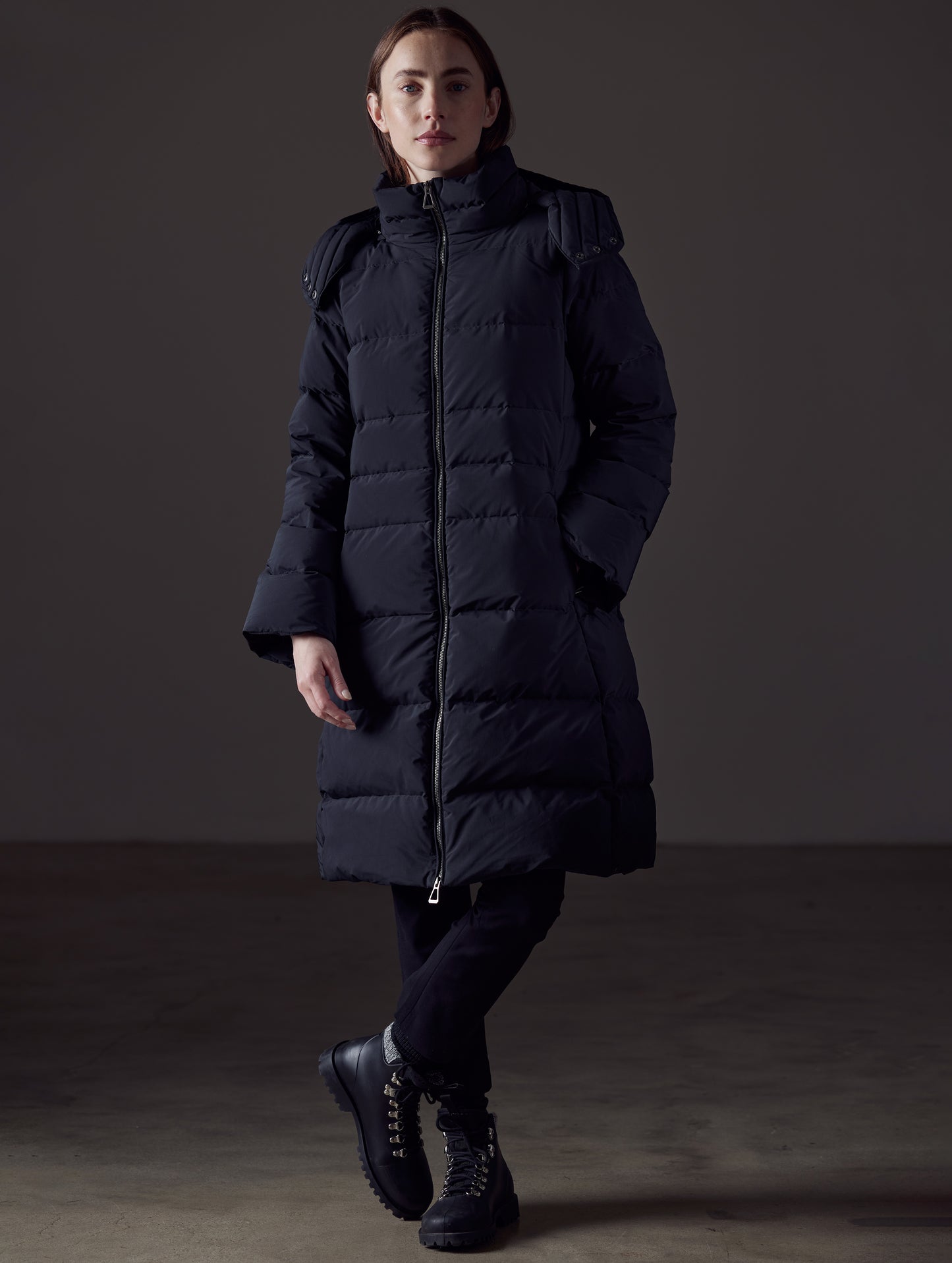 Front angled full-body view of woman wearing Stirling Jacket in Onyx Black from AETHER Apparel.