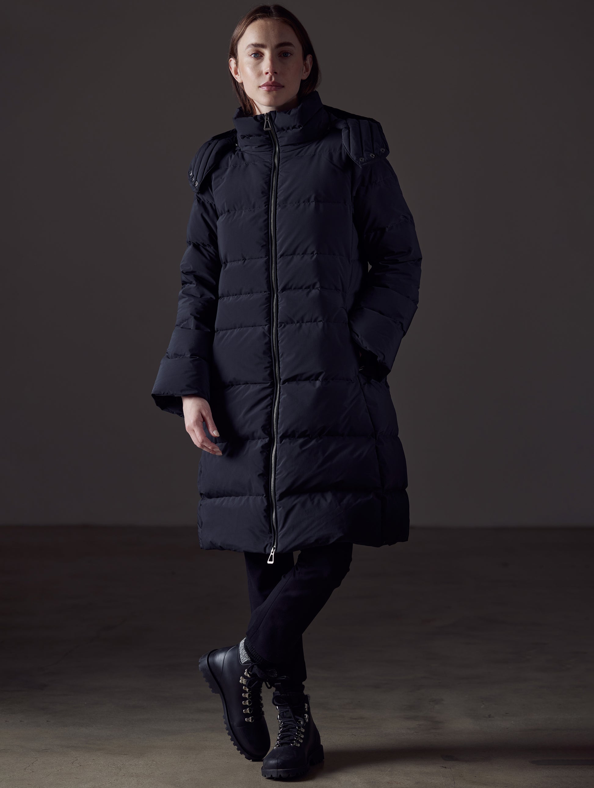 Front angled full-body view of woman wearing Stirling Jacket in Onyx Black from AETHER Apparel.