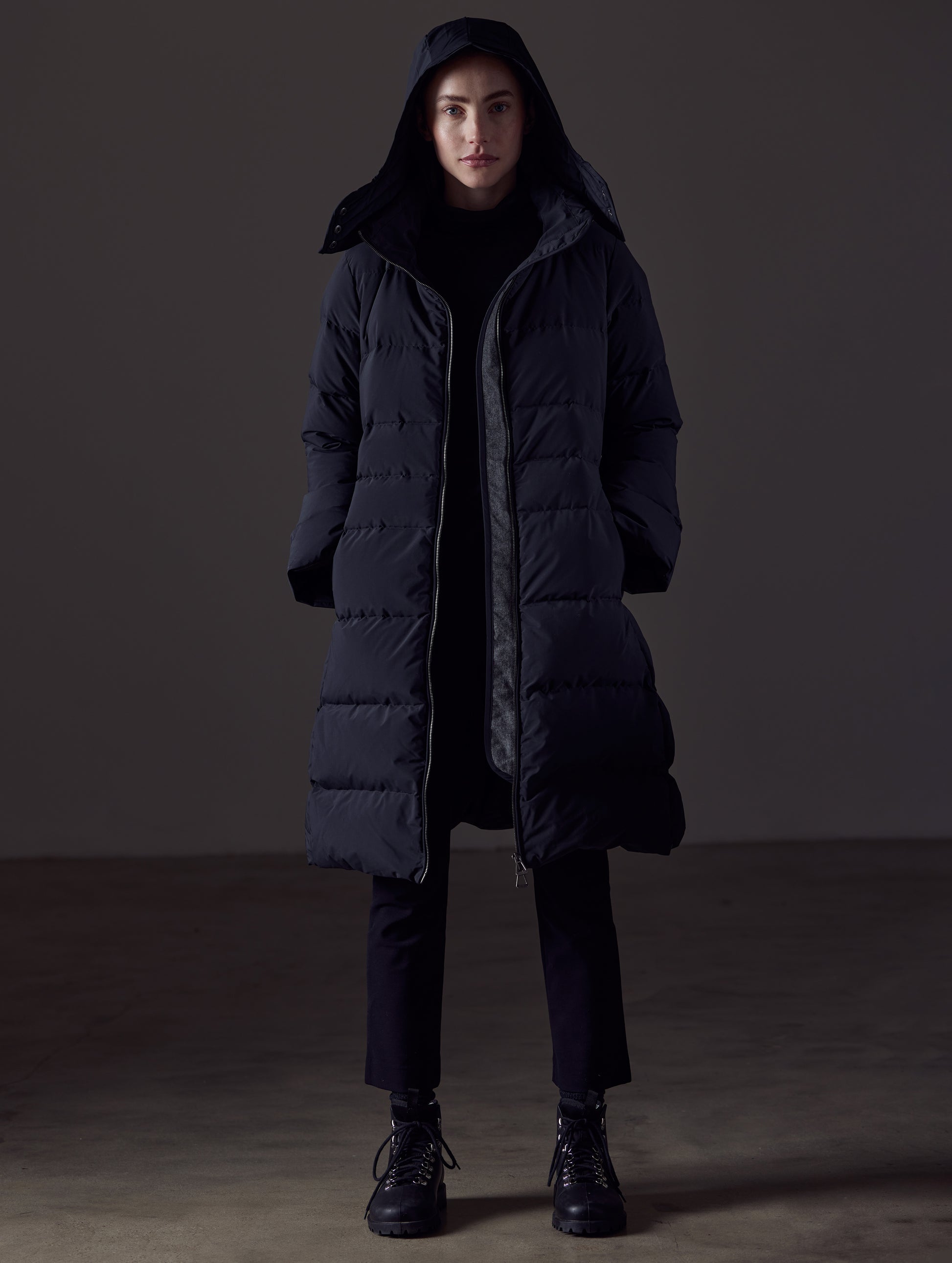 Front full-body view of woman wearing Stirling Jacket in Onyx Black from AETHER Apparel.