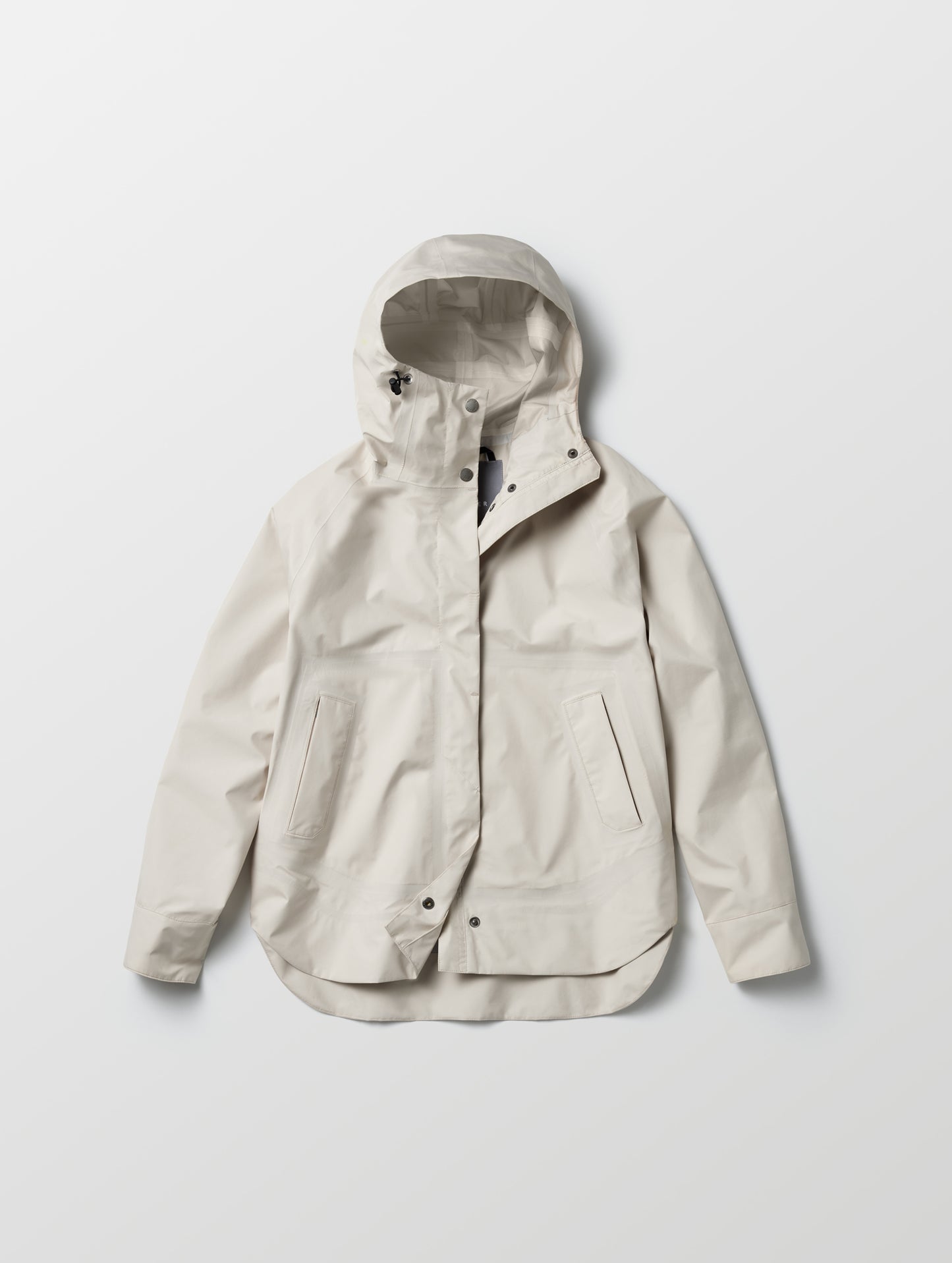 Flat lay view of women's Storm All-Weather Jacket in Bone white from AETHER Apparel.