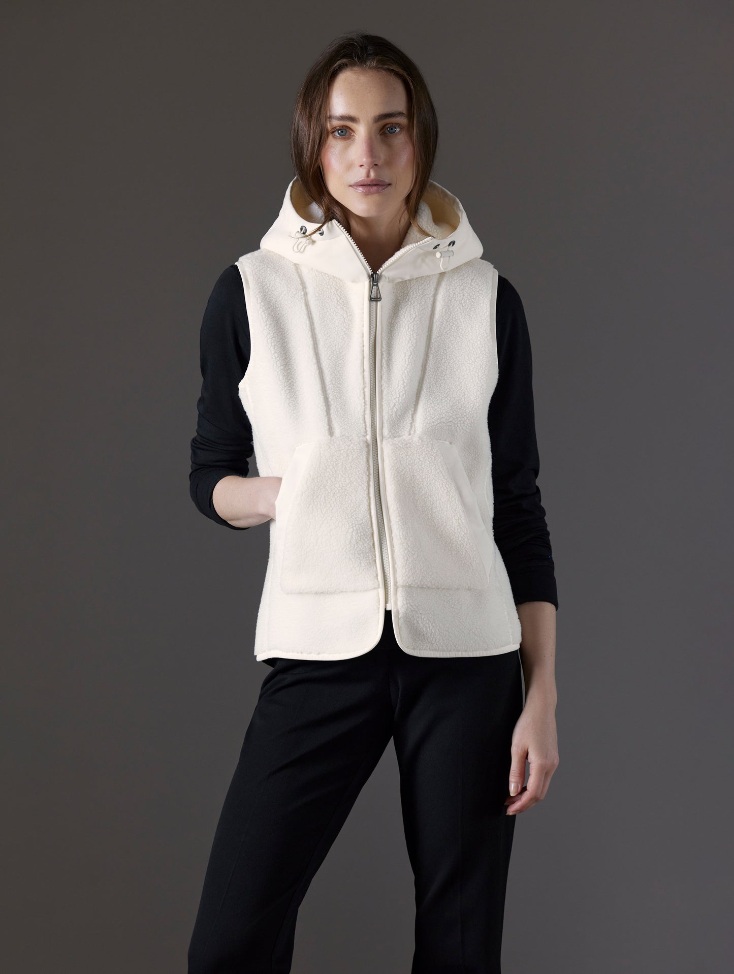 Front body view of woman wearing Terrain Fleece Vest in Winter White from AETHER Apparel.
