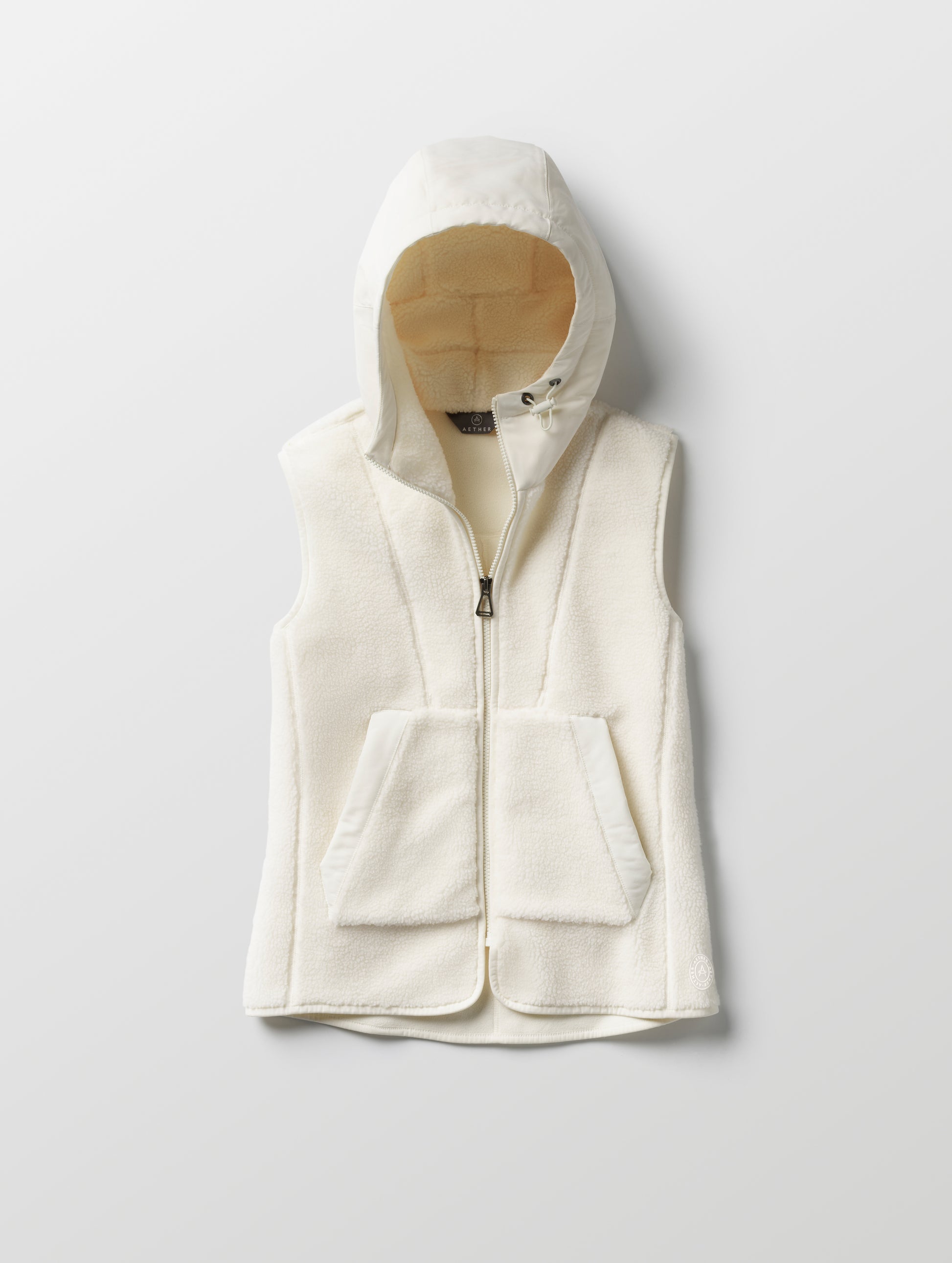 Flat lay of women’s Terrain Fleece Vest in Winter White from AETHER Apparel.