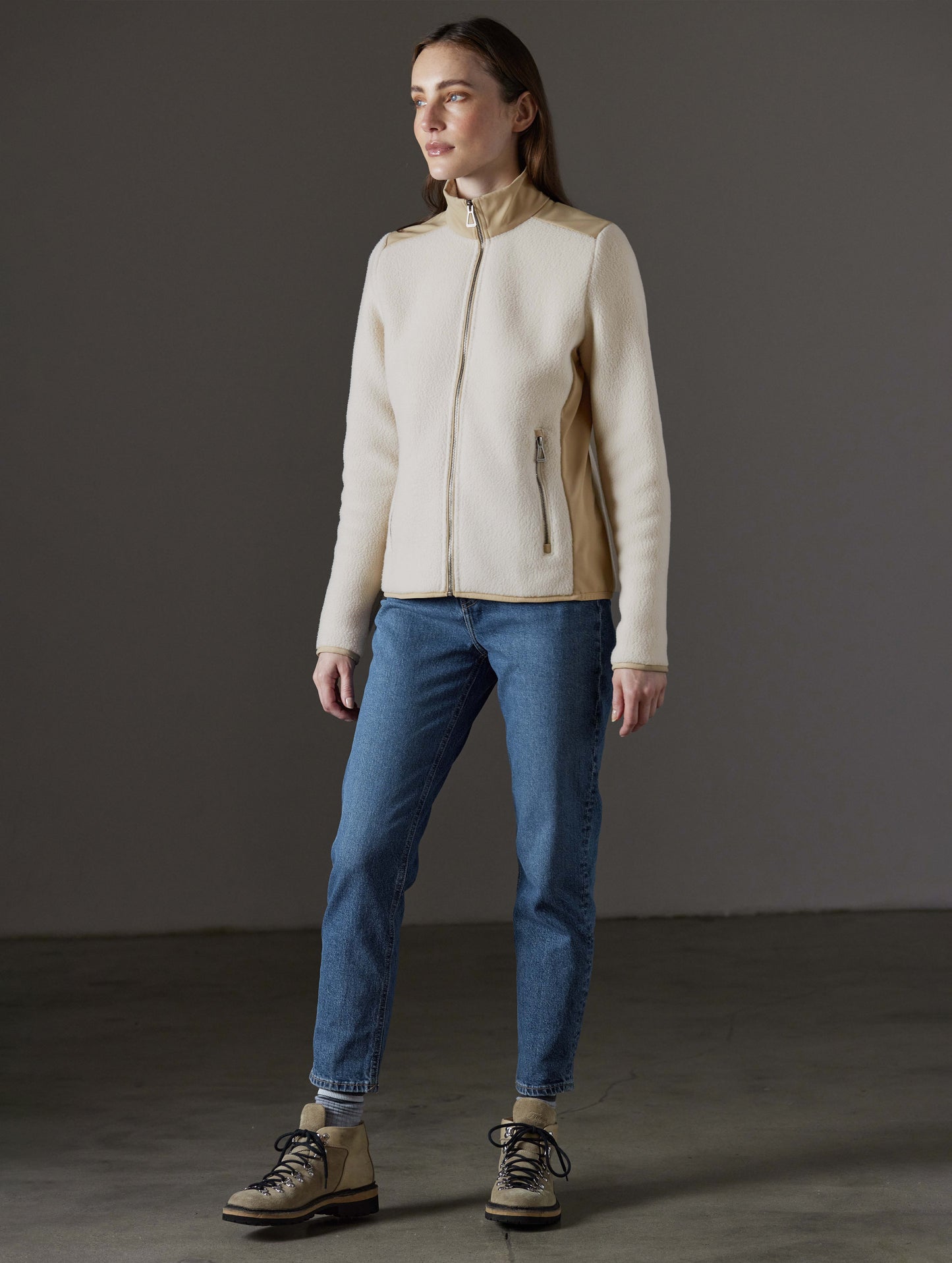 Front angled full-body view of woman wearing Walsh Full-Zip 2.0 in Bone and Desert Tan from AETHER Apparel.