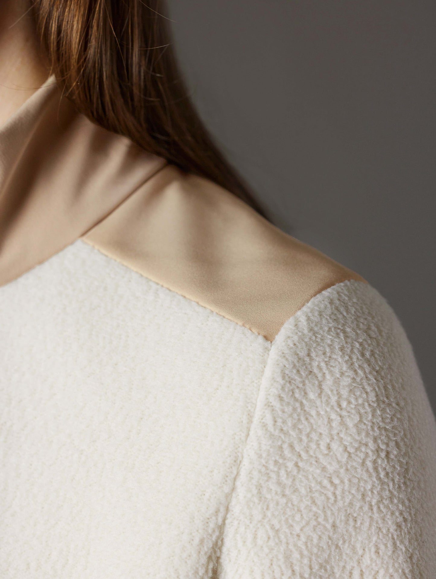 Closeup detailed view of contrasting soft touch synthetic panels on the shoulder of the Walsh Full-Zip 2.0 in Bone and Desert Tan from AETHER Apparel.