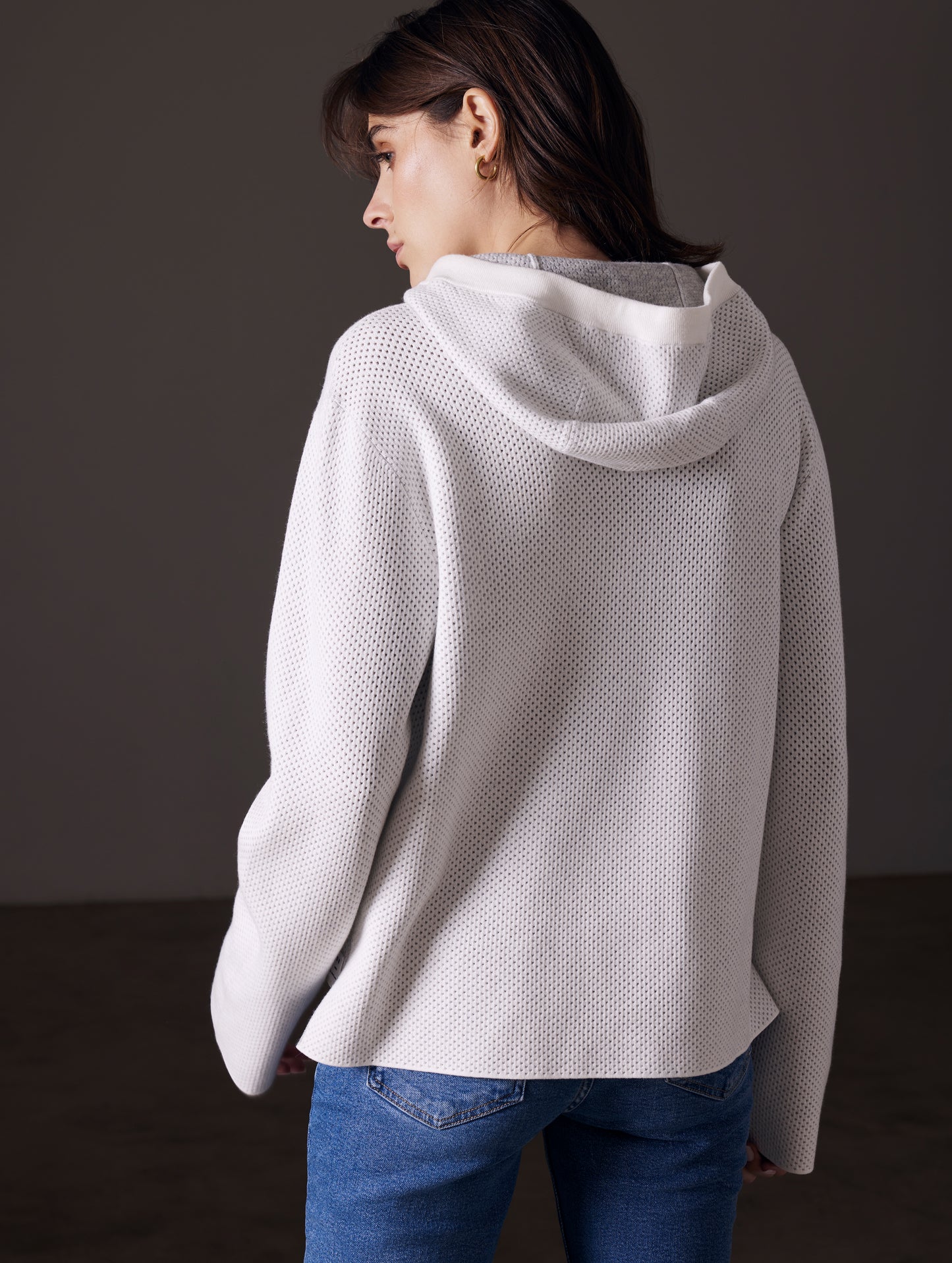 back view of woman wearing beige sweater from AETHER Apparel
