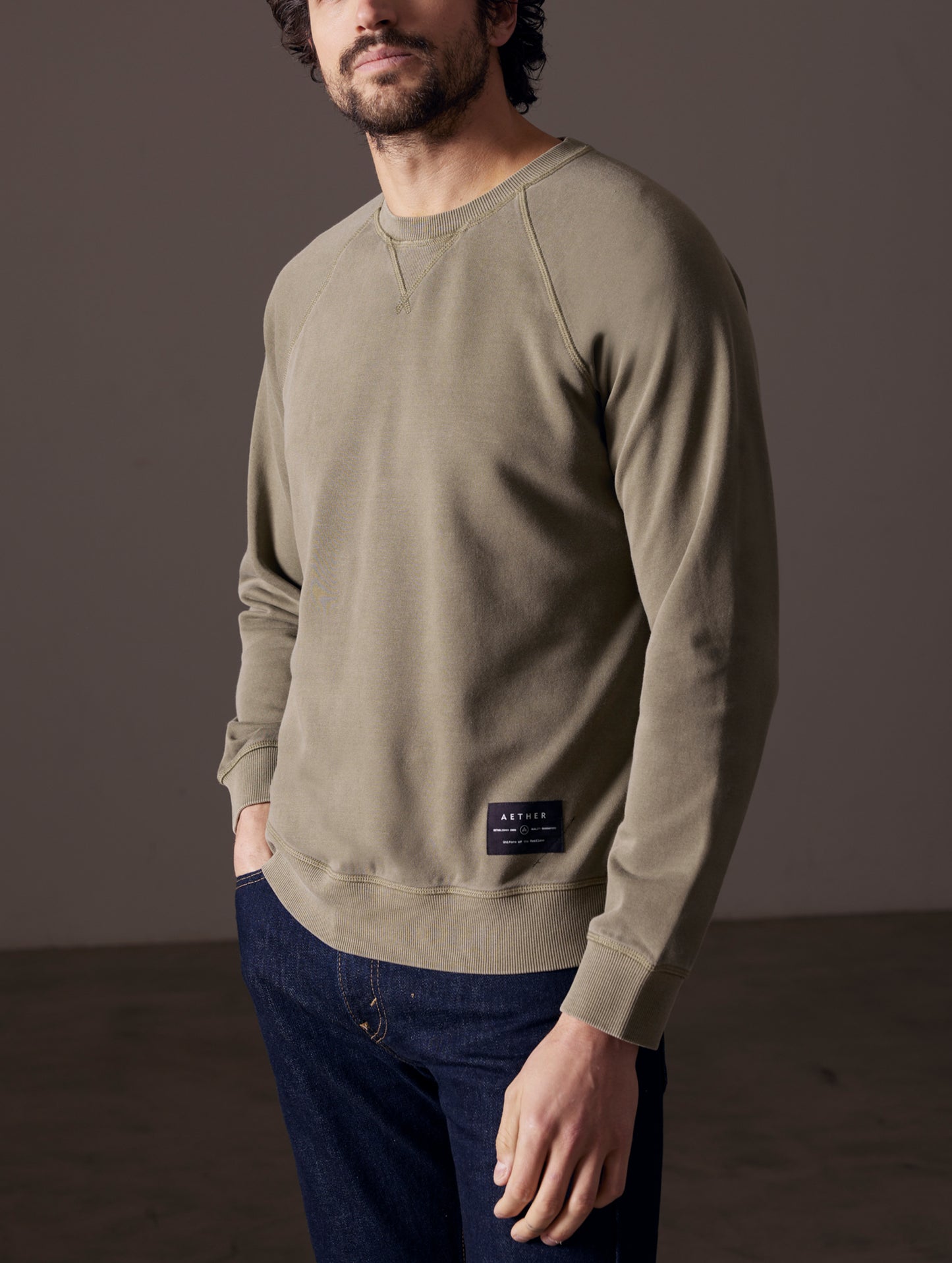 Front 3/4 body view of man wearing Solstice Lightweight Crew in Command Green from AETHER Apparel.