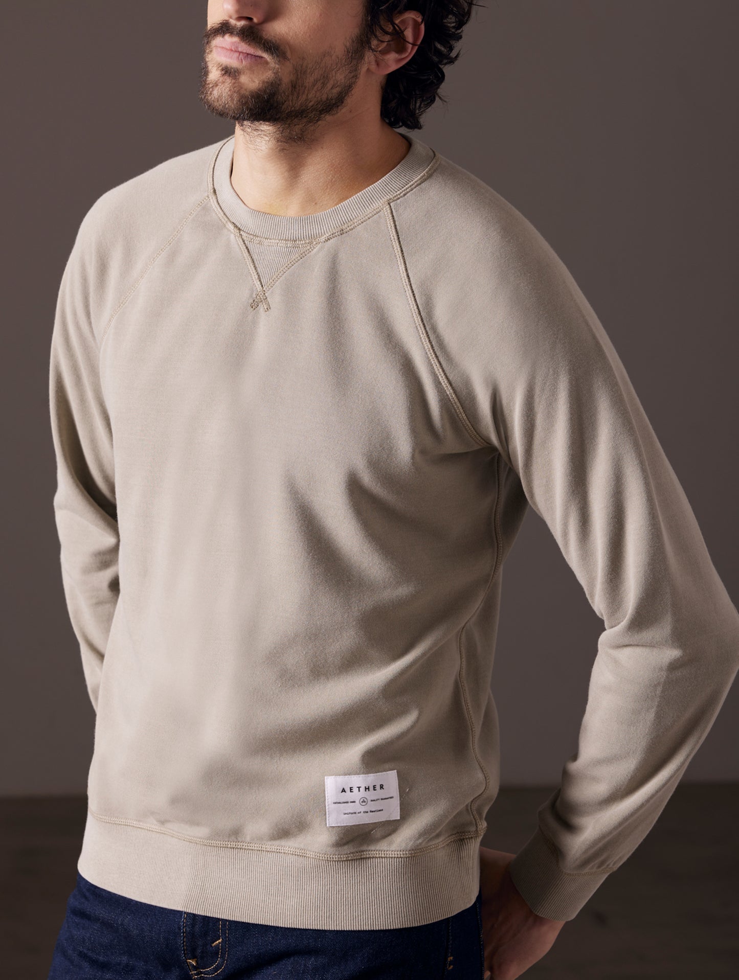Man wearing light grey crew sweatshirt