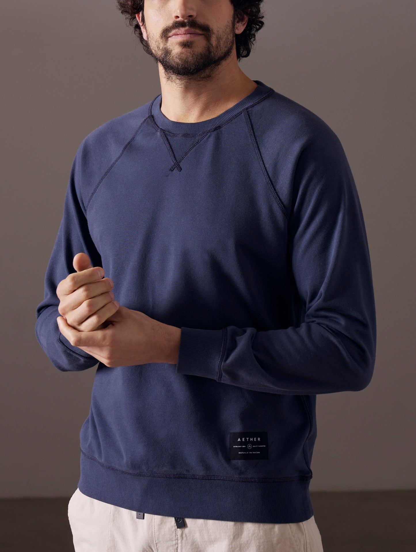 Man wearing blue crew sweatshirt