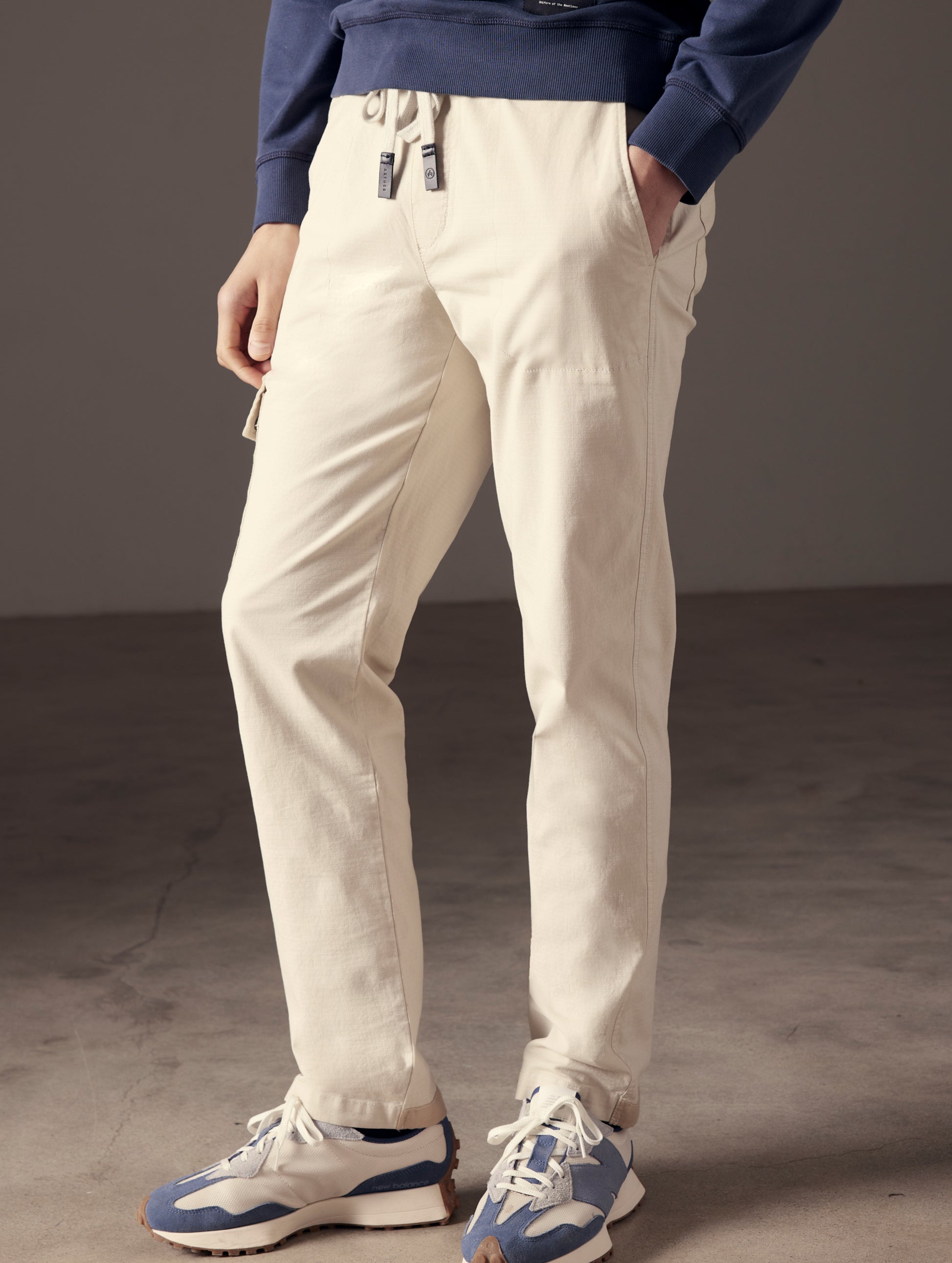 Man wearing beige Norton Cotton Ripstop Pant from AETHER Apparel.