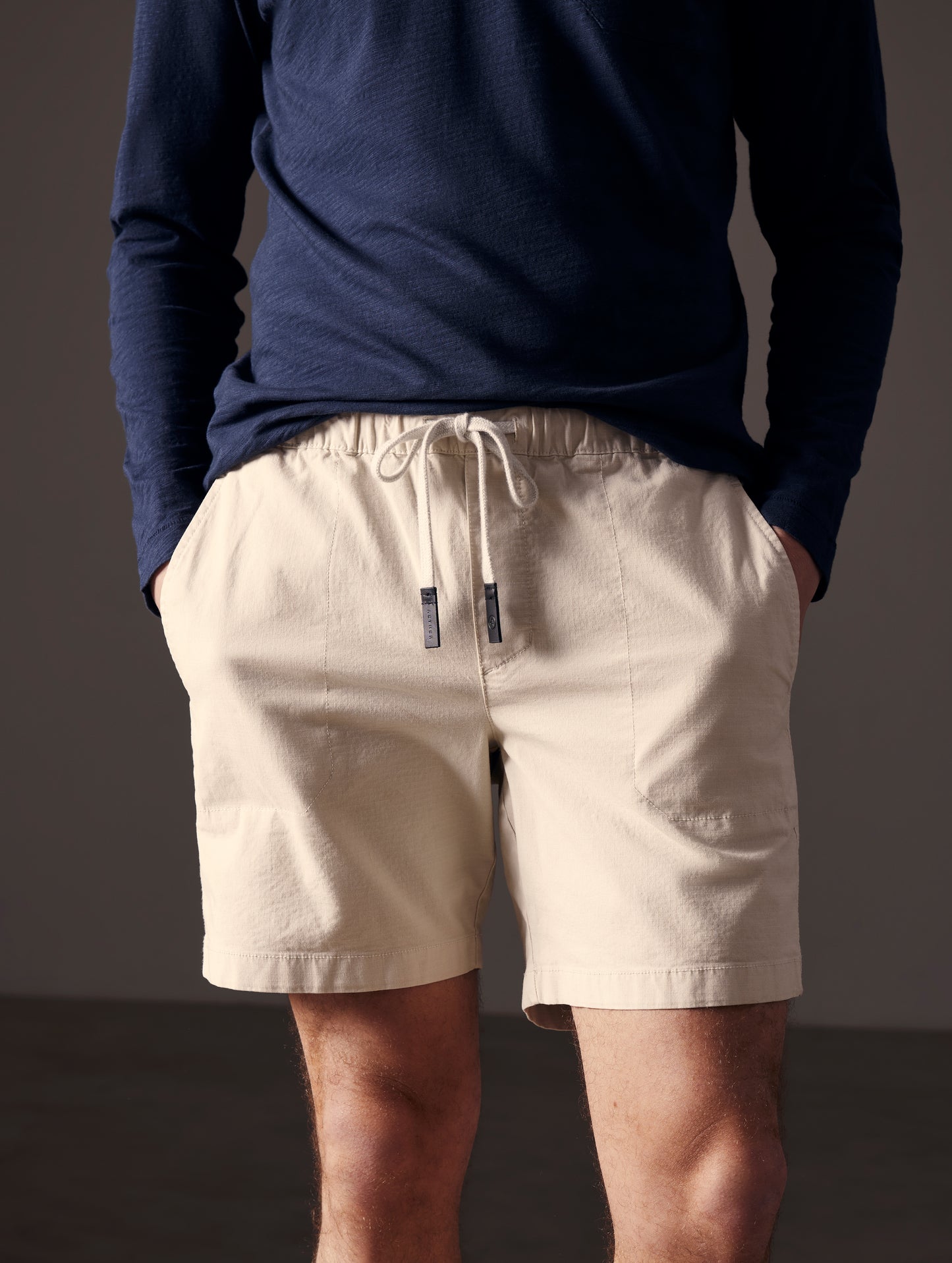 Front lower body view of man wearing Norton Cotton Ripstop Short in Bone white from AETHER Apparel.