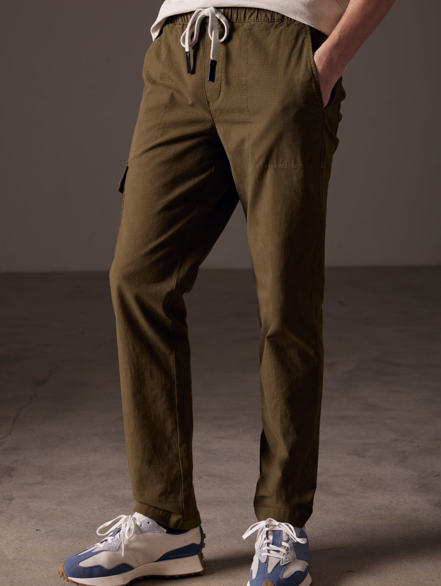 Man wearing green Norton Cotton Ripstop Pant from AETHER Apparel.