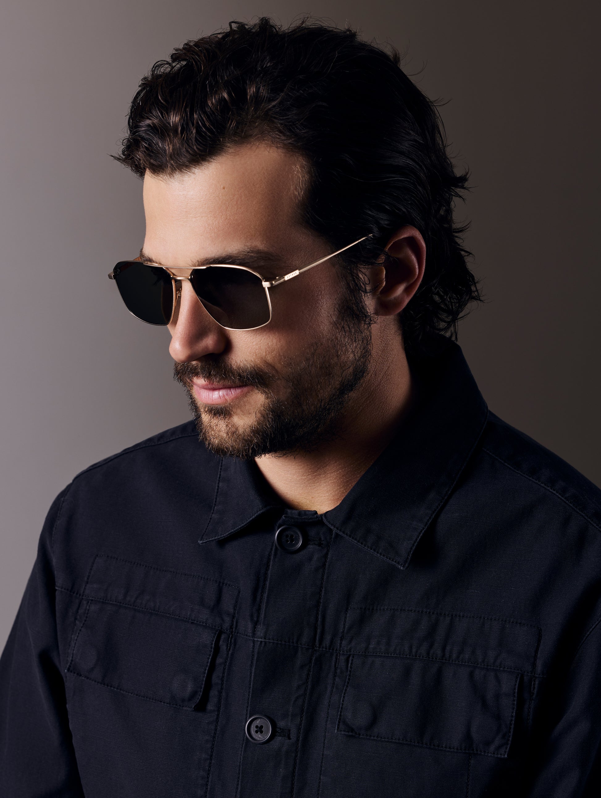 Front angled view of man wearing Arches Sunglass in Brushed Gold with Deep G15 Lens from AETHER Apparel.