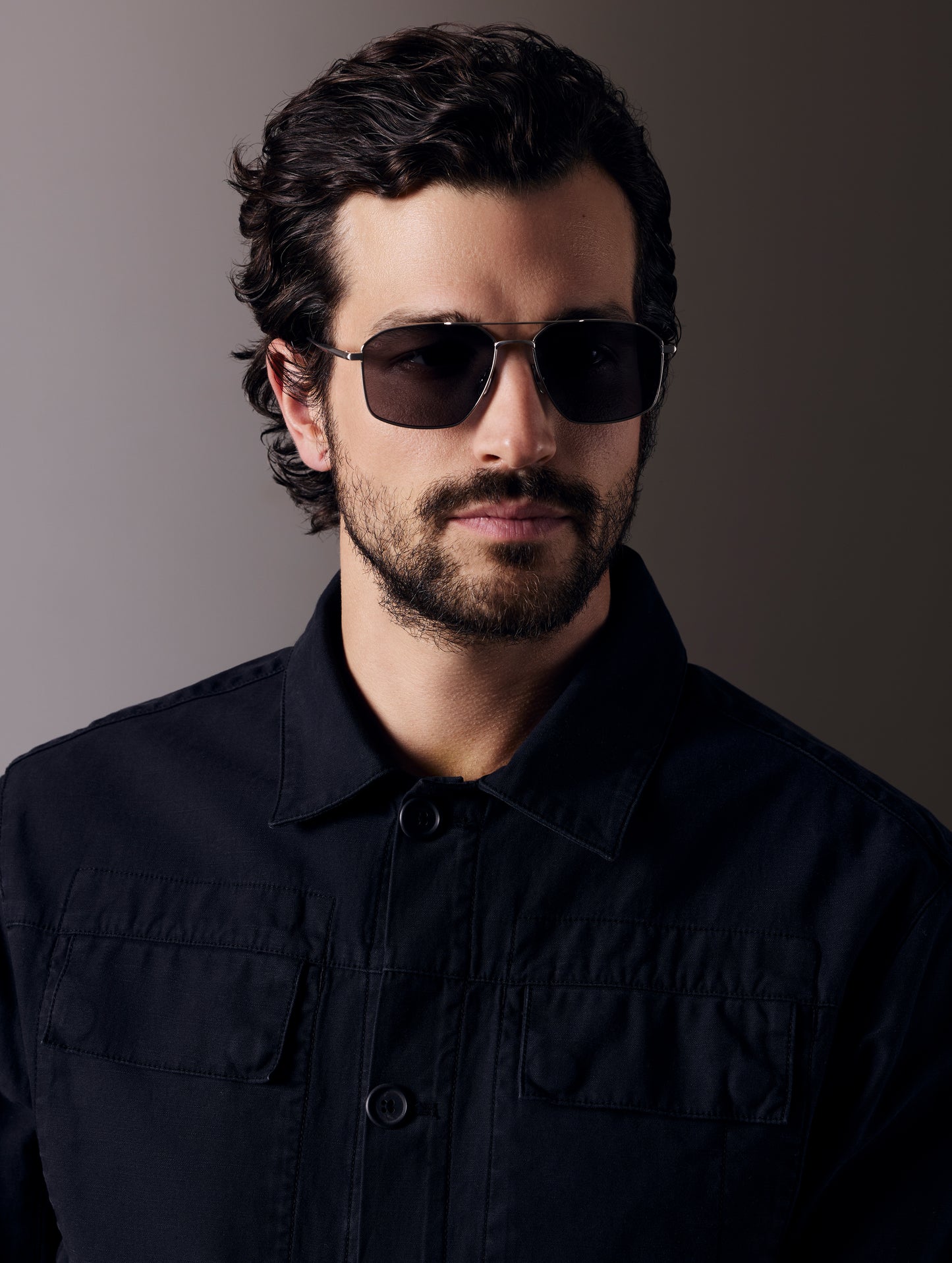 Front view of man wearing Arches Sunglass in Brushed Silver with Grey Lens from AETHER Apparel.