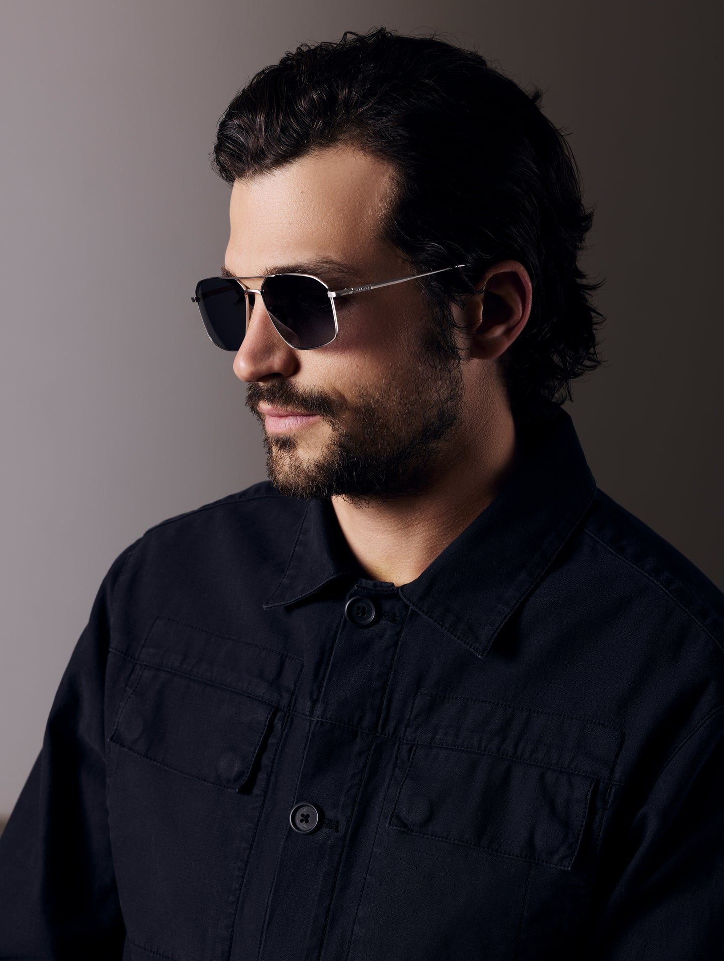 Front angled view of man wearing Arches Sunglass in Brushed Silver with Grey Lens from AETHER Apparel.