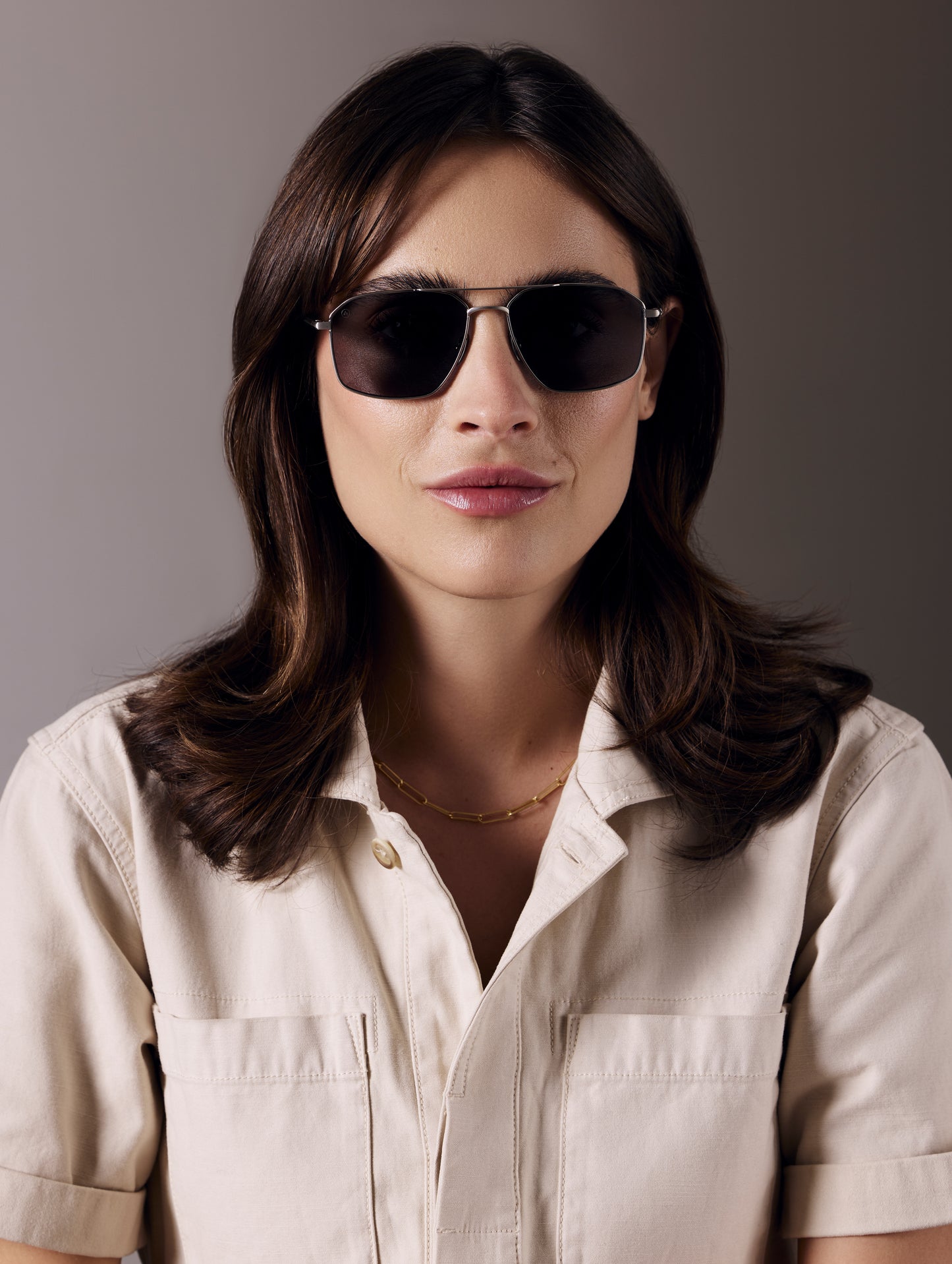 Front view of woman wearing Arches Sunglass in Brushed Silver with Grey Lens from AETHER Apparel.