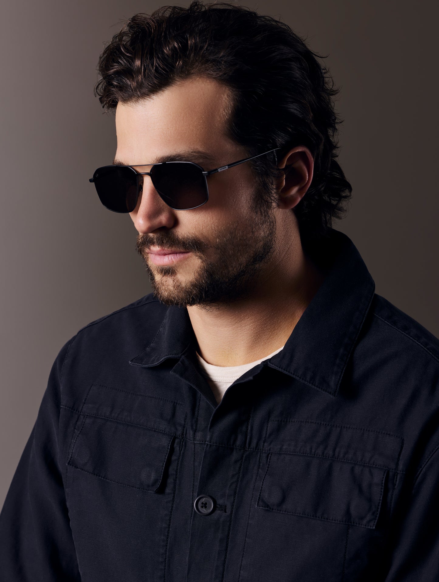 Front angled view of man wearing Arches Sunglass in Black with Black Lens from AETHER Apparel.