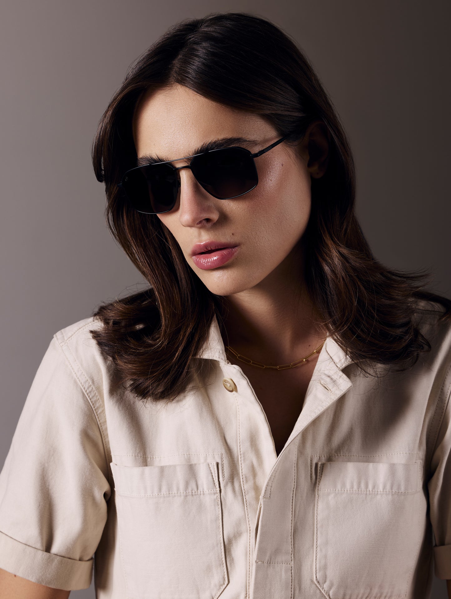Front angled view of woman wearing Arches Sunglass in Black with Black Lens from AETHER Apparel.