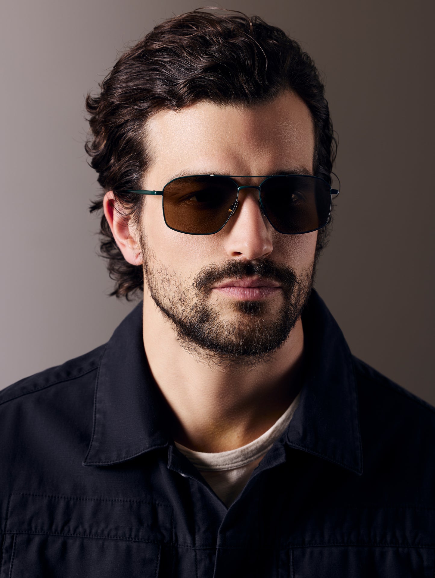 Front view of man wearing Arches Sunglass in Green with Brown Lens from AETHER Apparel.