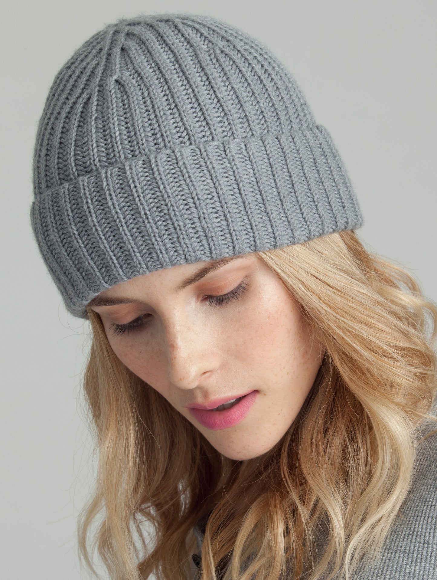 Close view of woman wearing Atlas Hat in Heather Grey from AETHER Apparel.