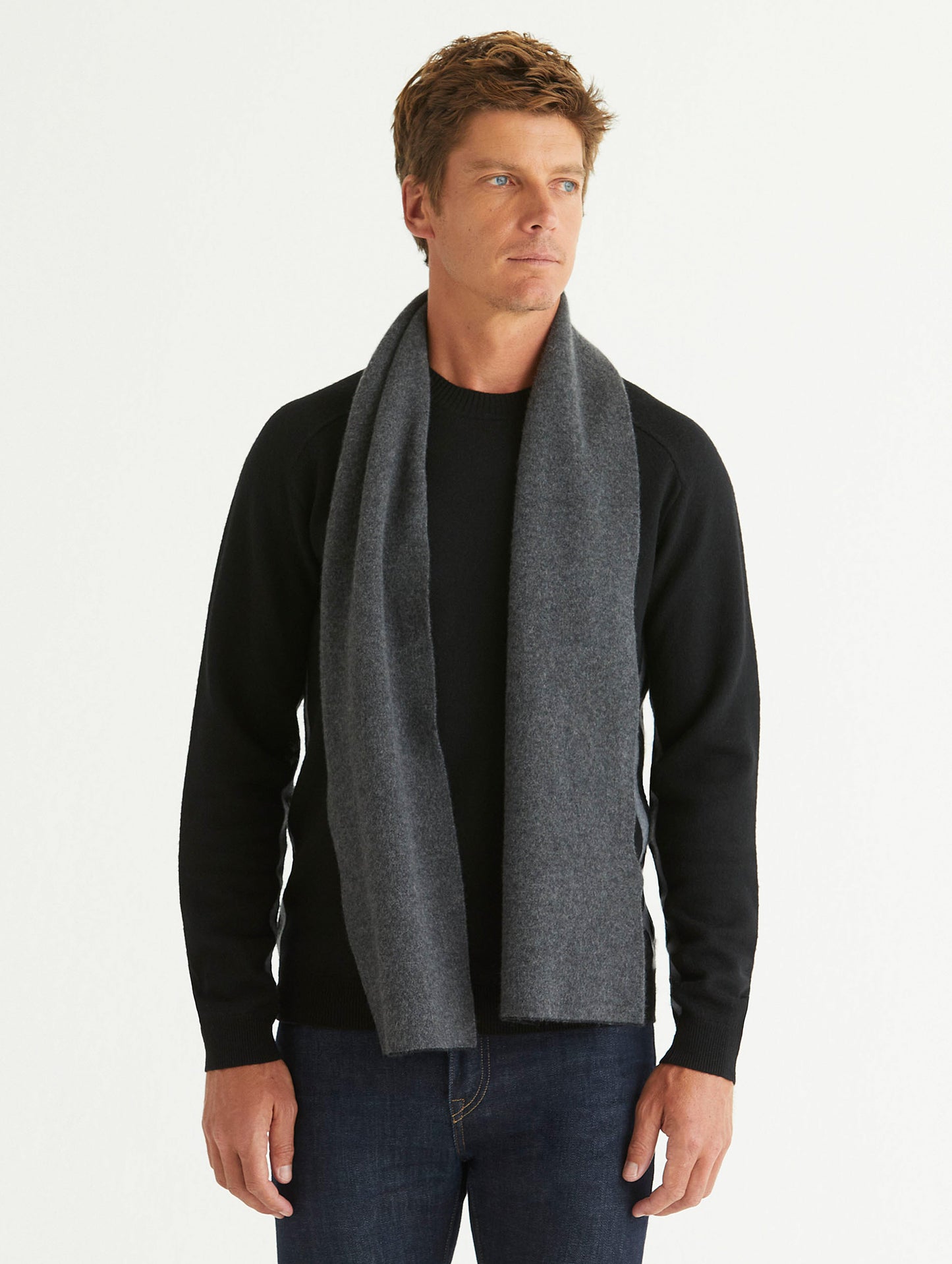 Front full-body view of man wearing Avesta Cashmere Scarf in Onyx Black from AETHER Apparel.