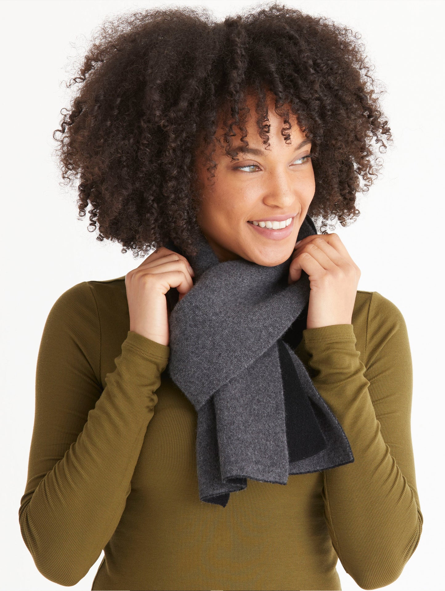 Front view of woman wearing Avesta Cashmere Scarf in Onyx Black from AETHER Apparel.