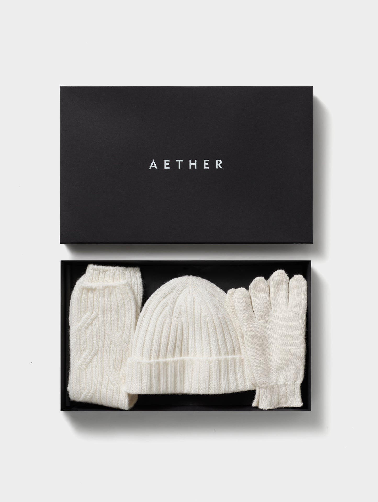 White cashmere hat, socks, and gloves from AETHER Apparel