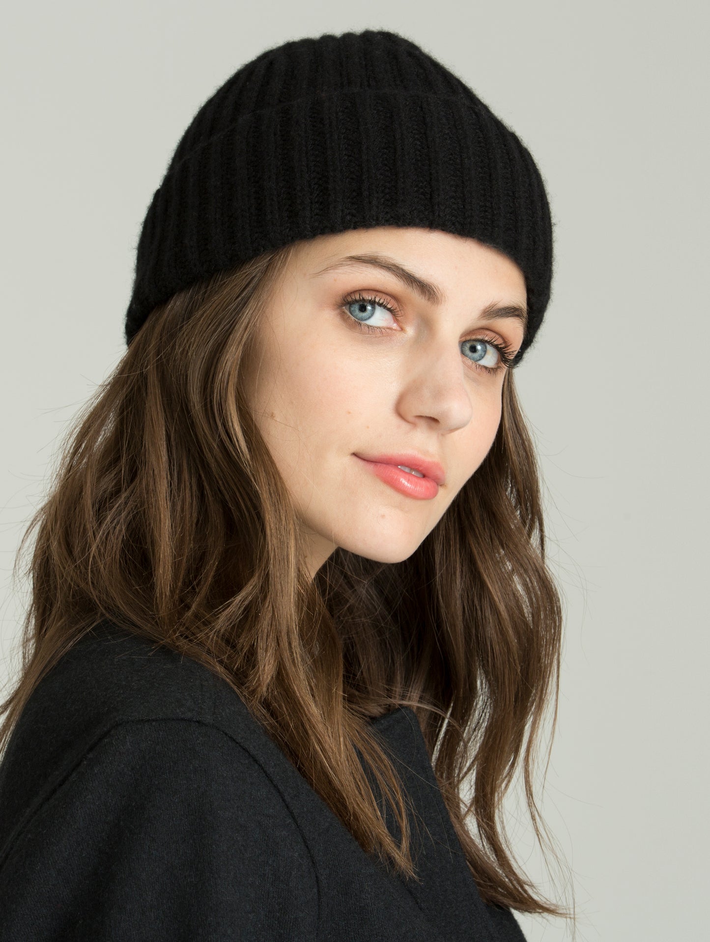 Front angled view of woman wearing Cashmere Hat in Jet Black from AETHER Apparel.