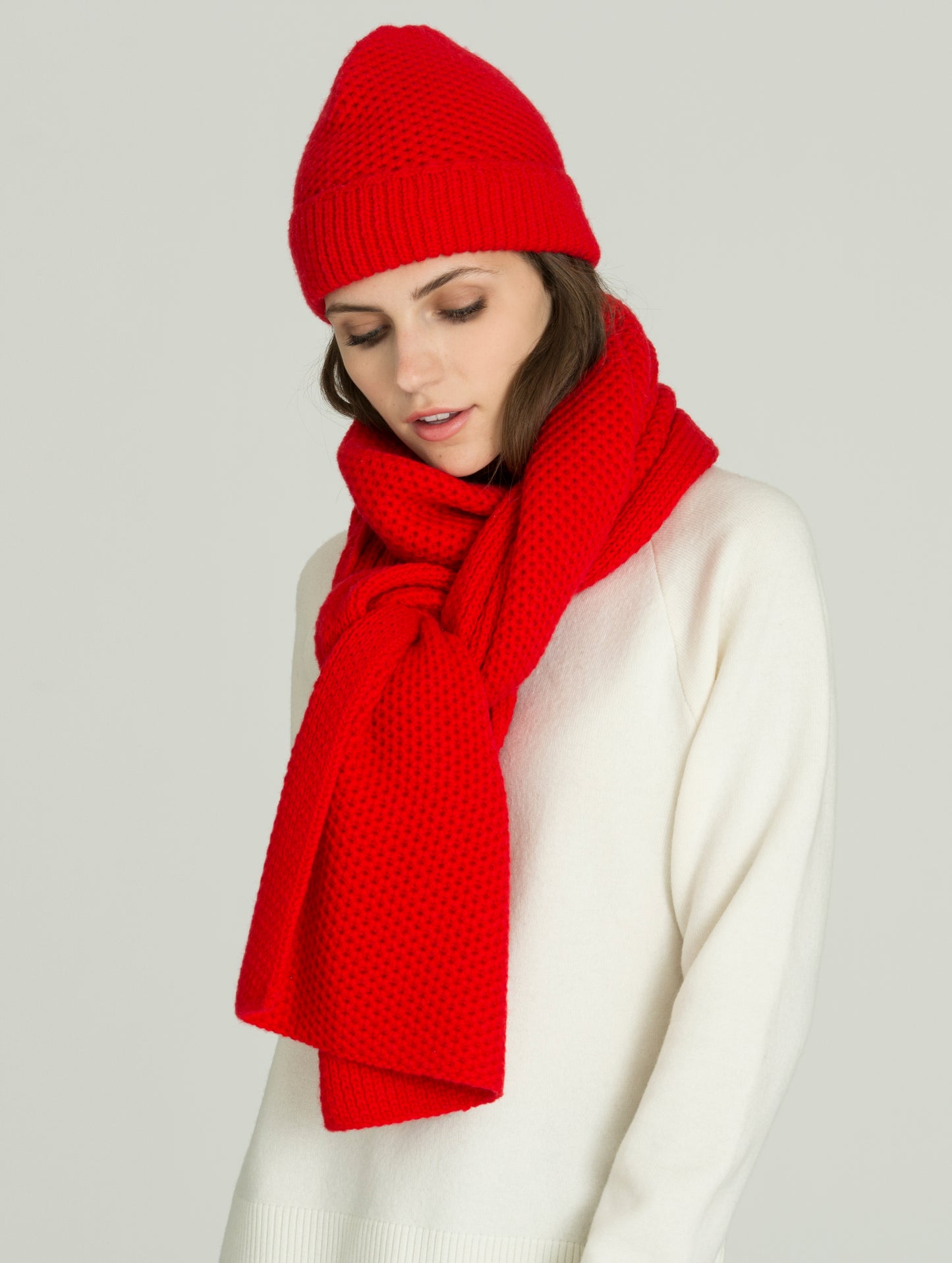 Angled view of woman wearing red Luxe Scarf from AETHER Apparel.