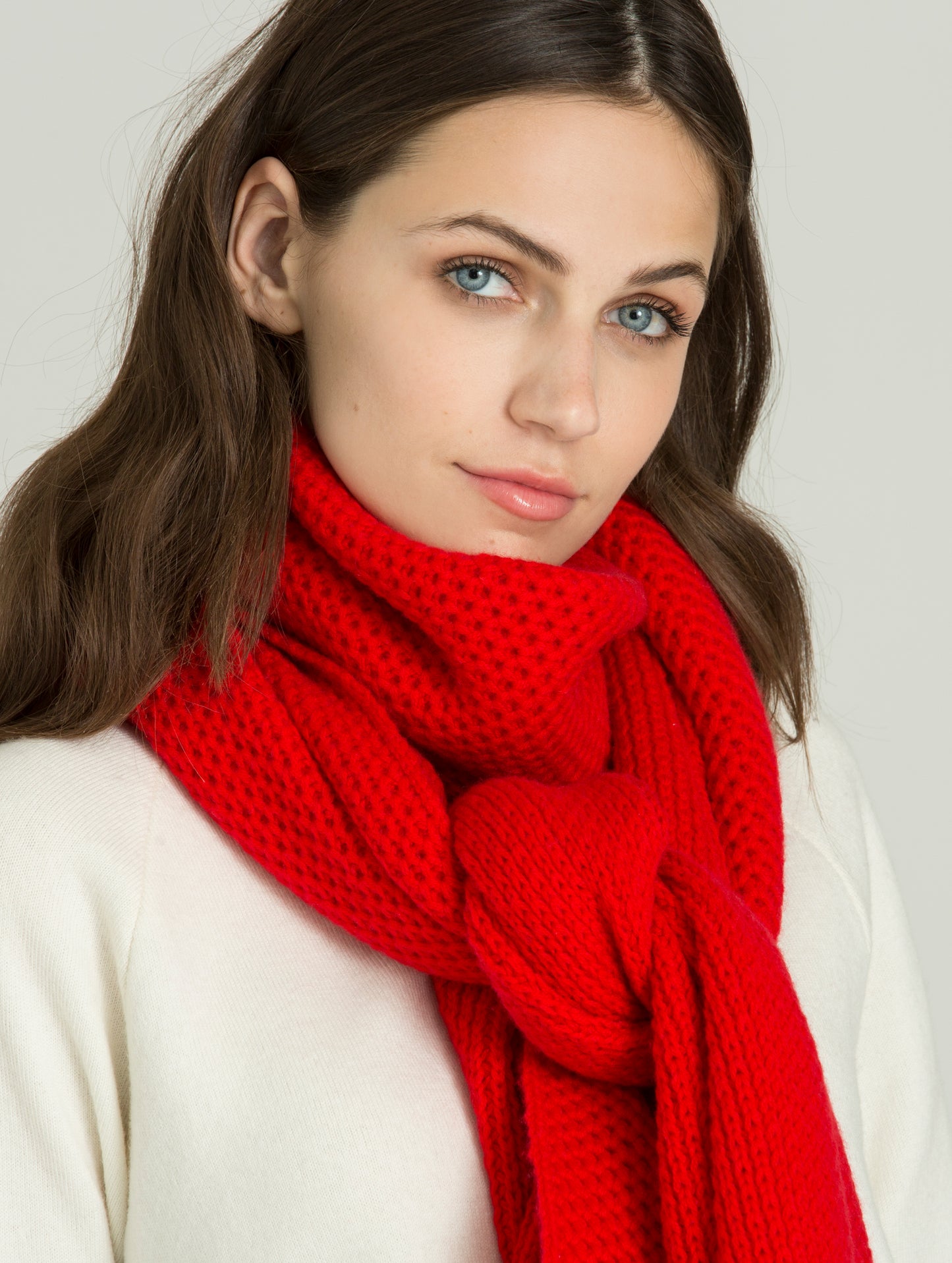 Close view of woman wearing red Luxe Scarf from AETHER Apparel.