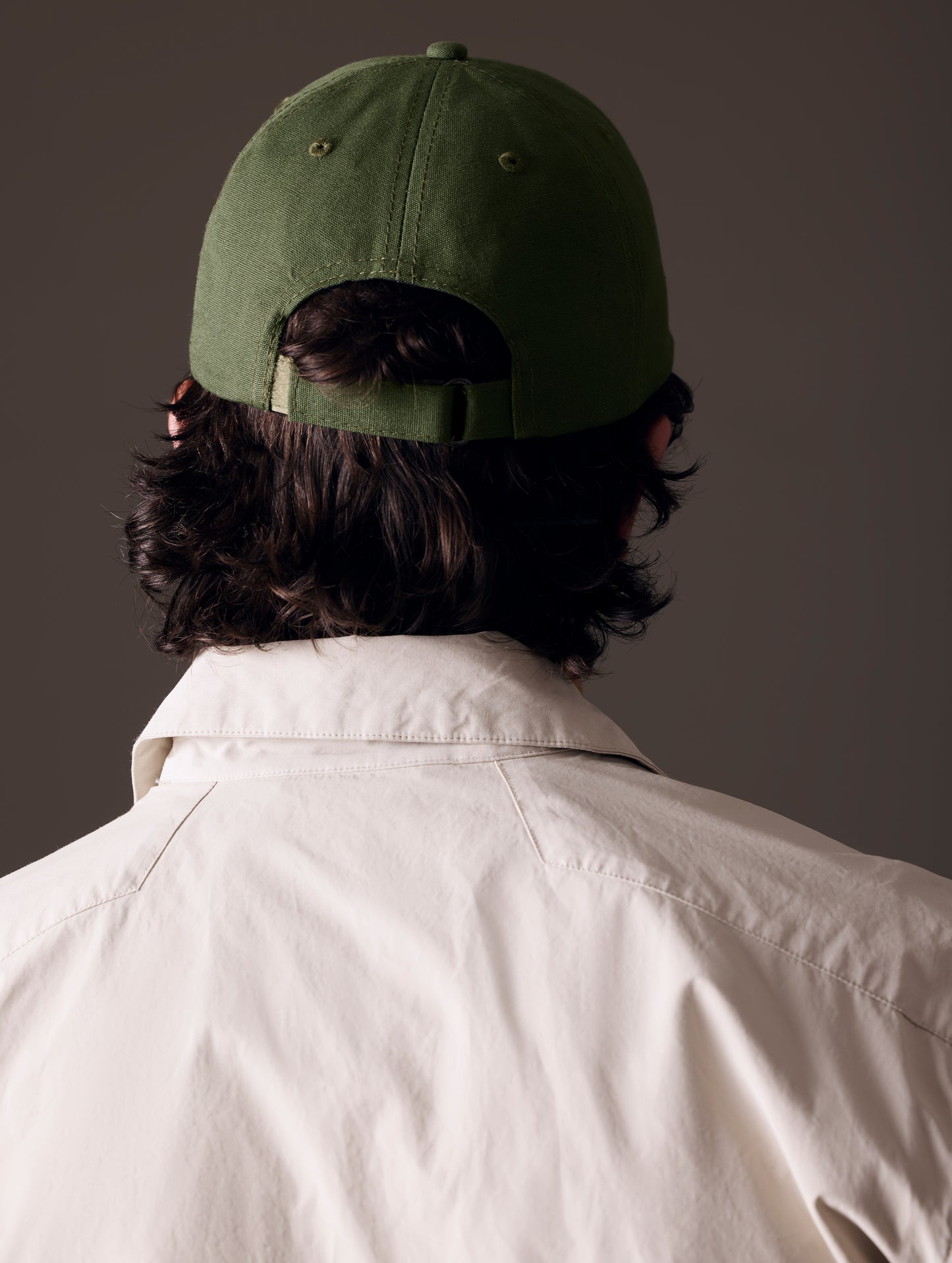 Rear view of man wearing AETHER Mountain Hat in Army Green from AETHER Apparel.