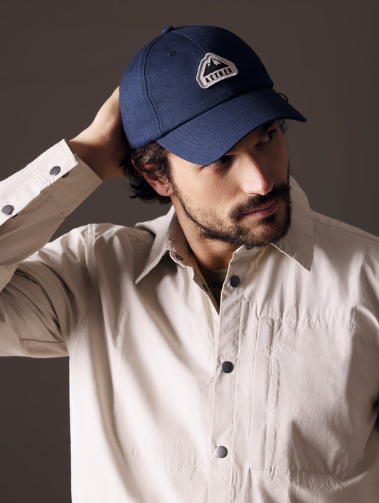 Front angled view of man wearing AETHER Mountain Hat in Nordic Navy blue from AETHER Apparel.