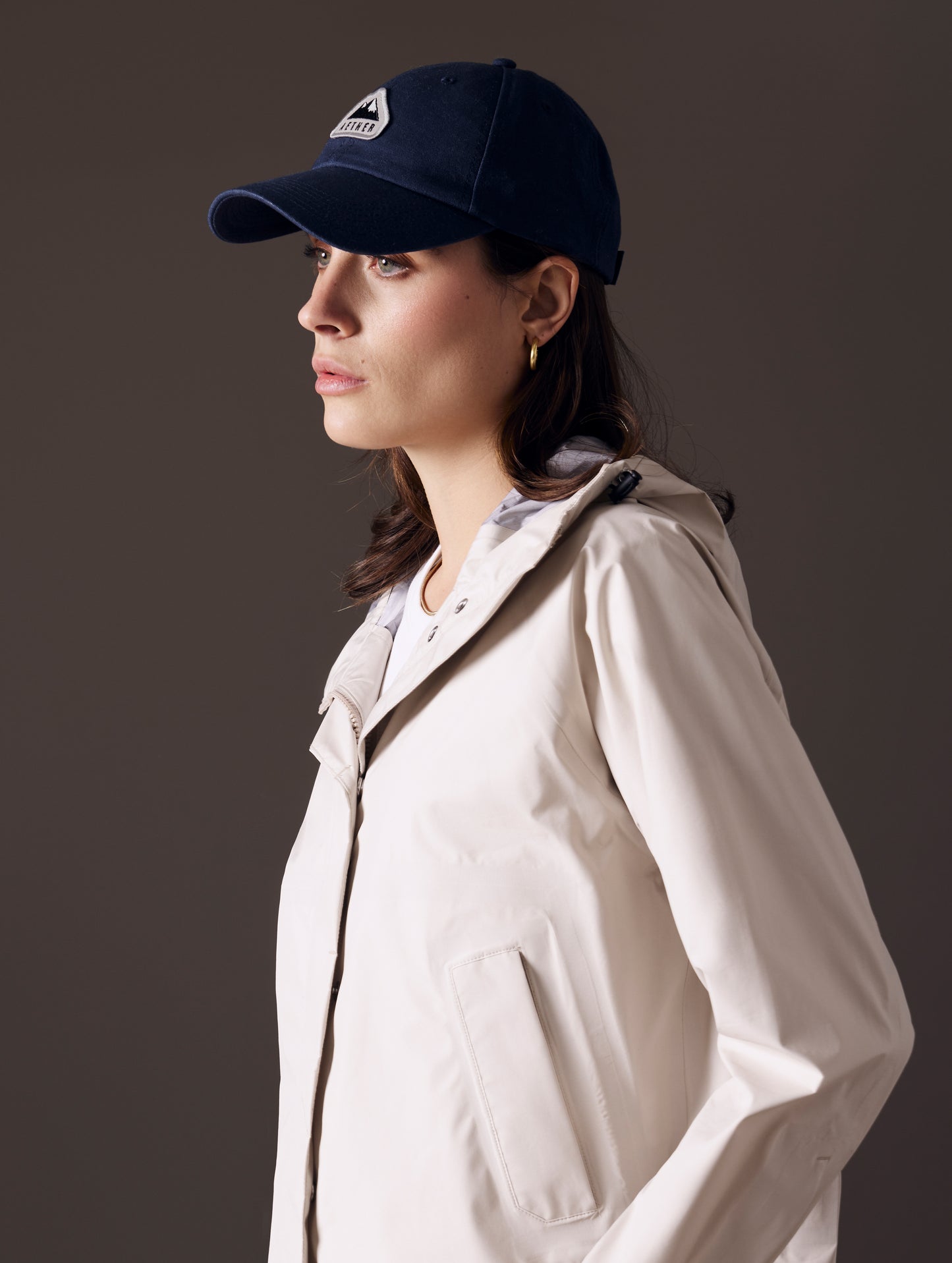 Front angled view of woman wearing AETHER Mountain Hat in Nordic Navy blue from AETHER Apparel.