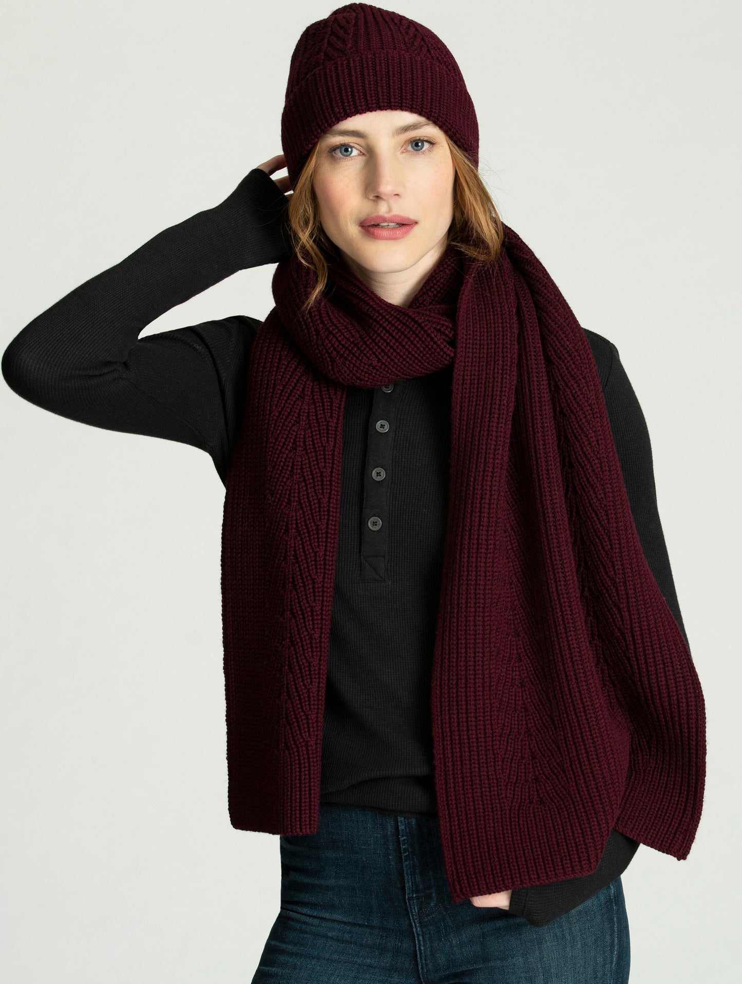 Woman wearing burgundy Peak Scarf from AETHER Apparel and matching beanie.