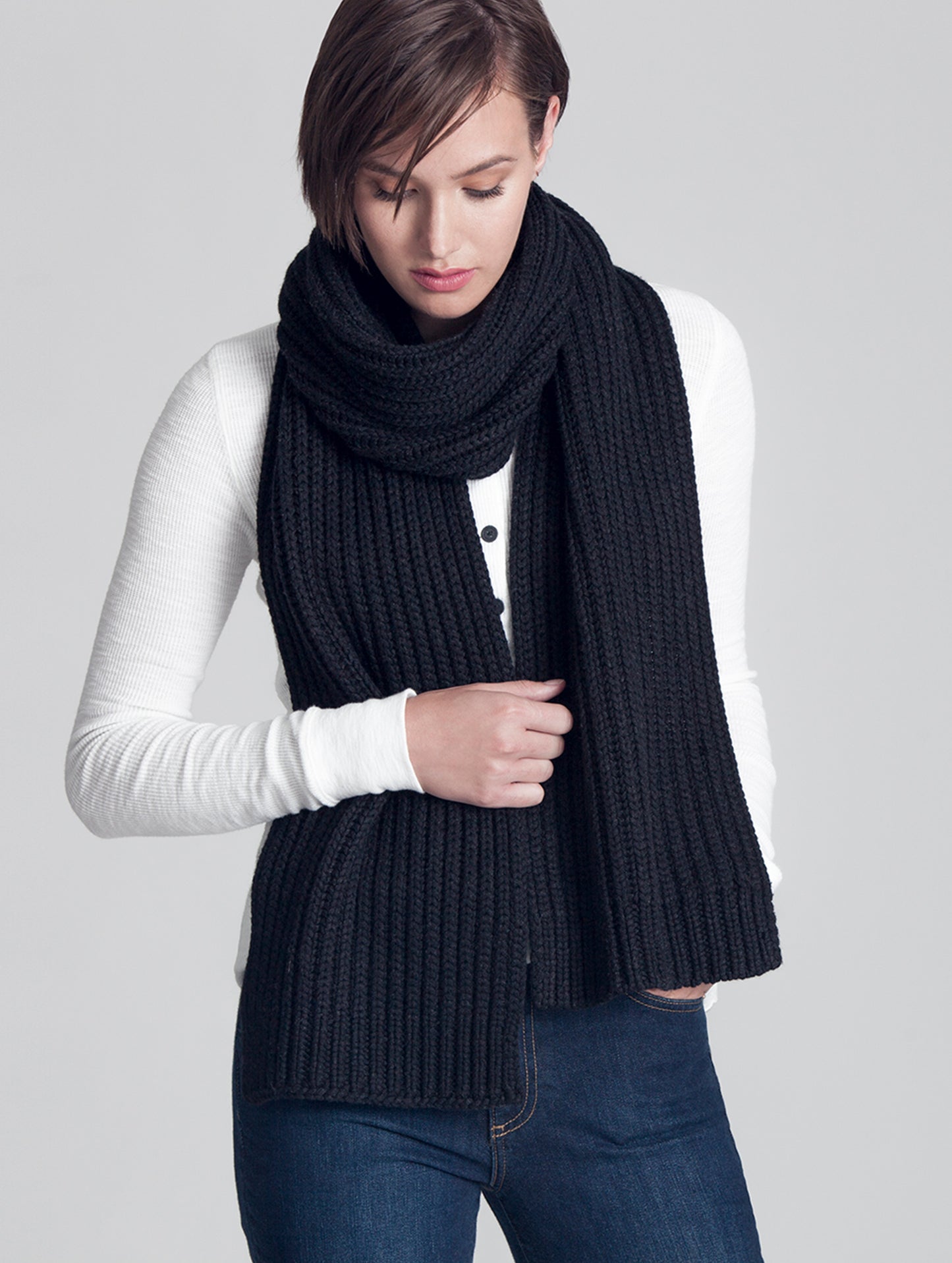 Woman wearing black Seasons Scarf from AETHER Apparel.