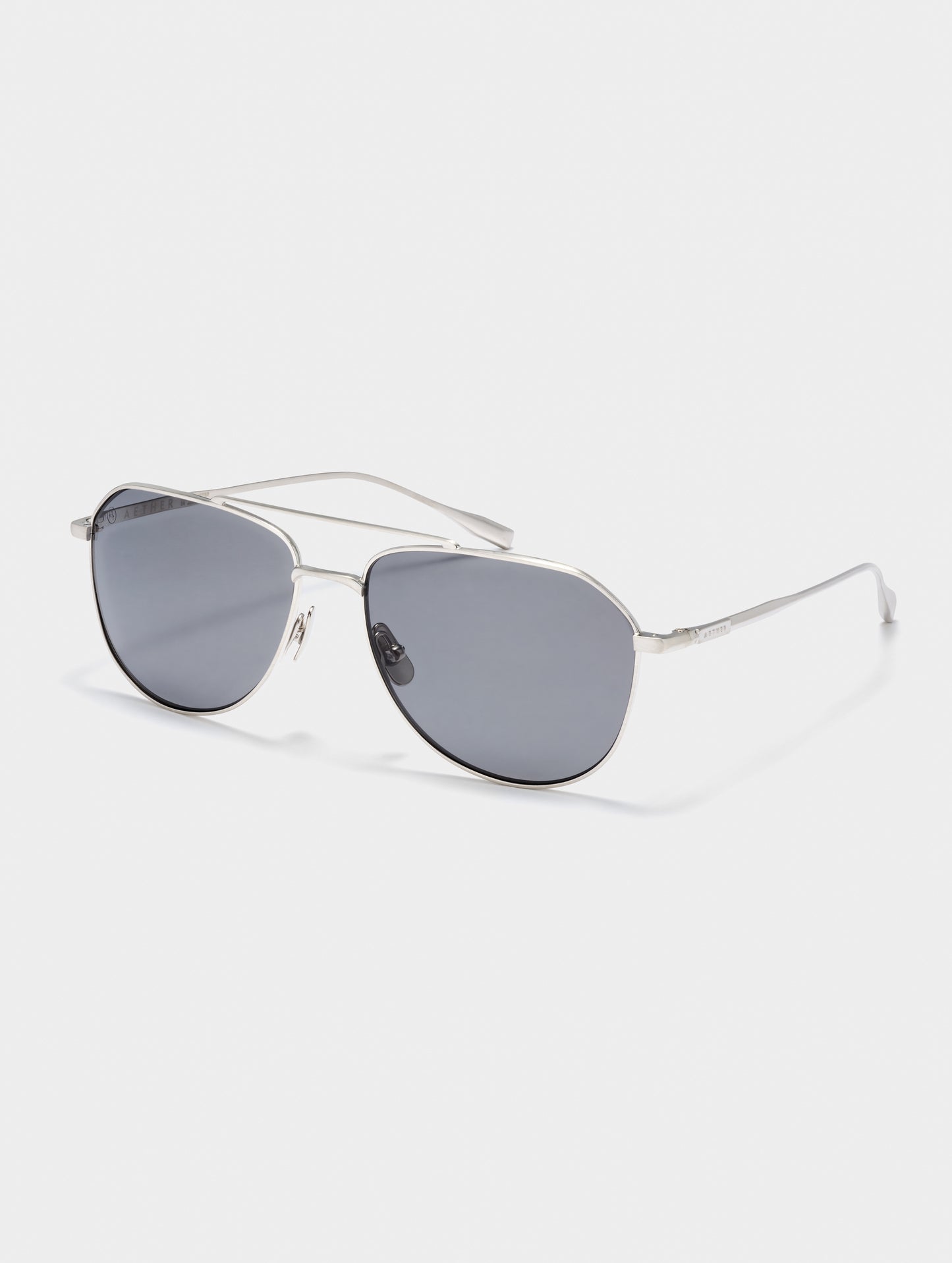 Front 3/4 view of Bryce Sunglass in Brushed Silver titanium with Grey Lens from AETHER Apparel.