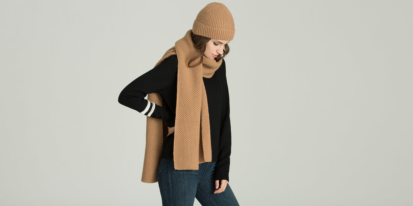 Angled view of woman wearing tan Luxe Scarf from AETHER Apparel.