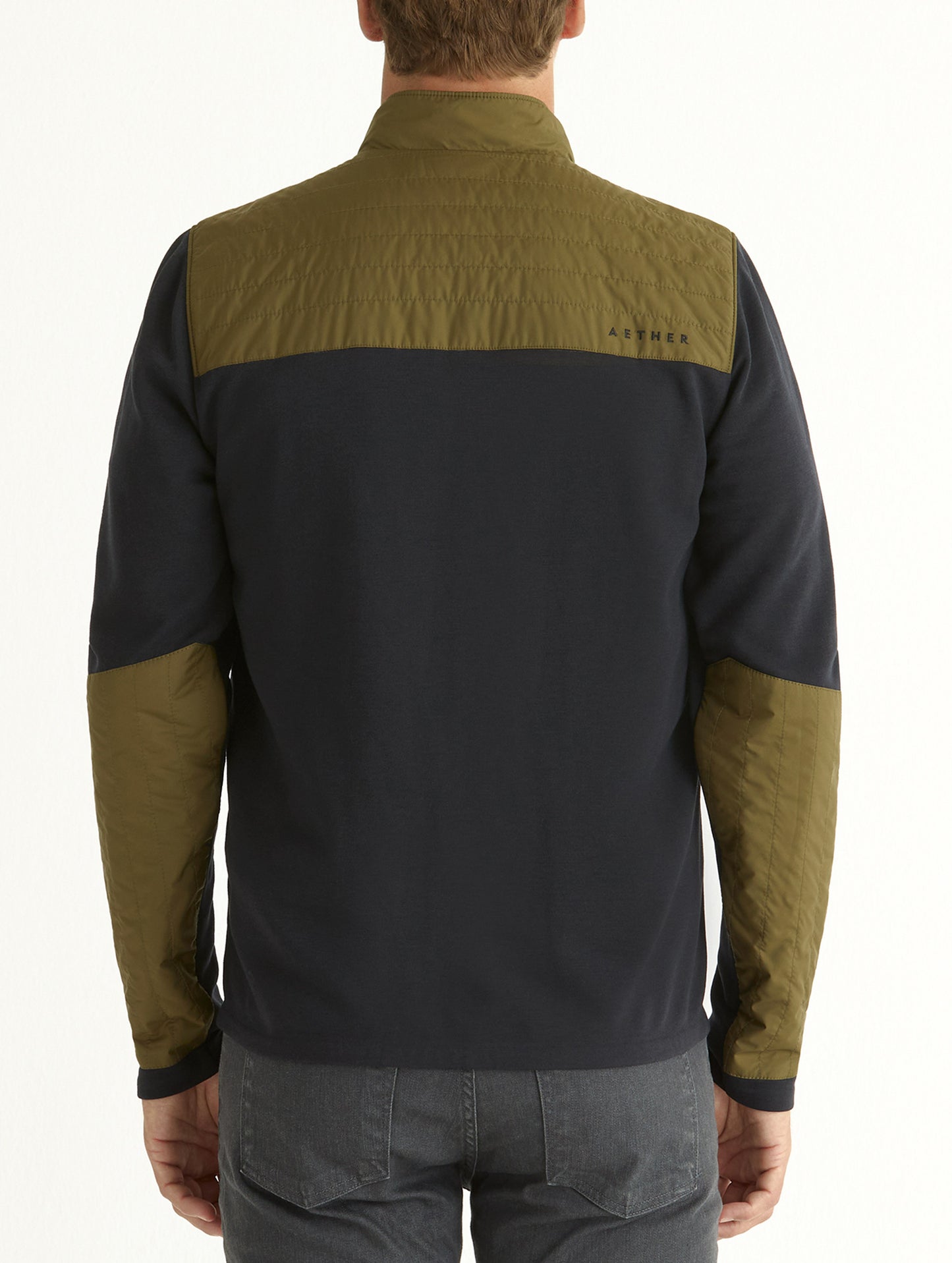 Back view of man wearing green Canton Jacket from AETHER Apparel.
