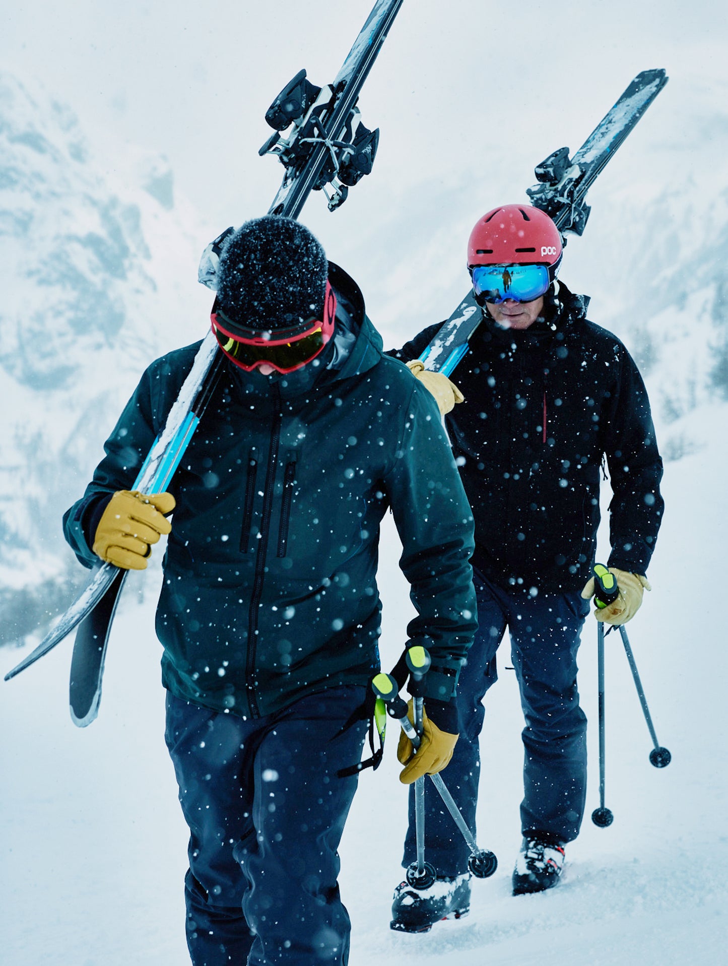 Outdoor lifestyle image of men walking through snow wearing Catalyst Snow Shells from AETHER Apparel.