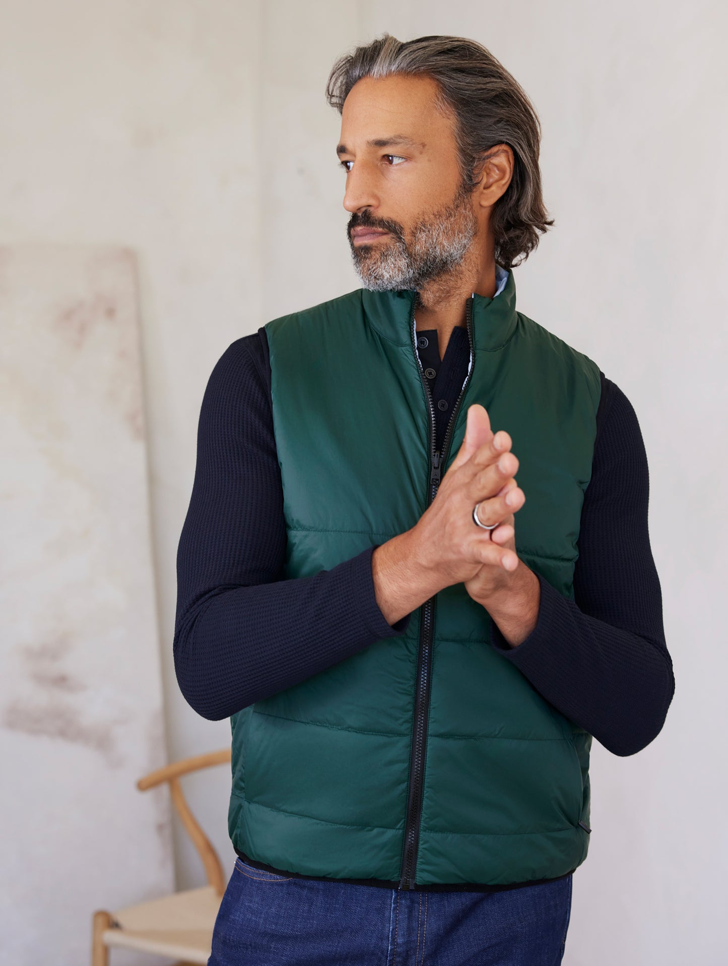 man wearing green side of reversible insulated vest