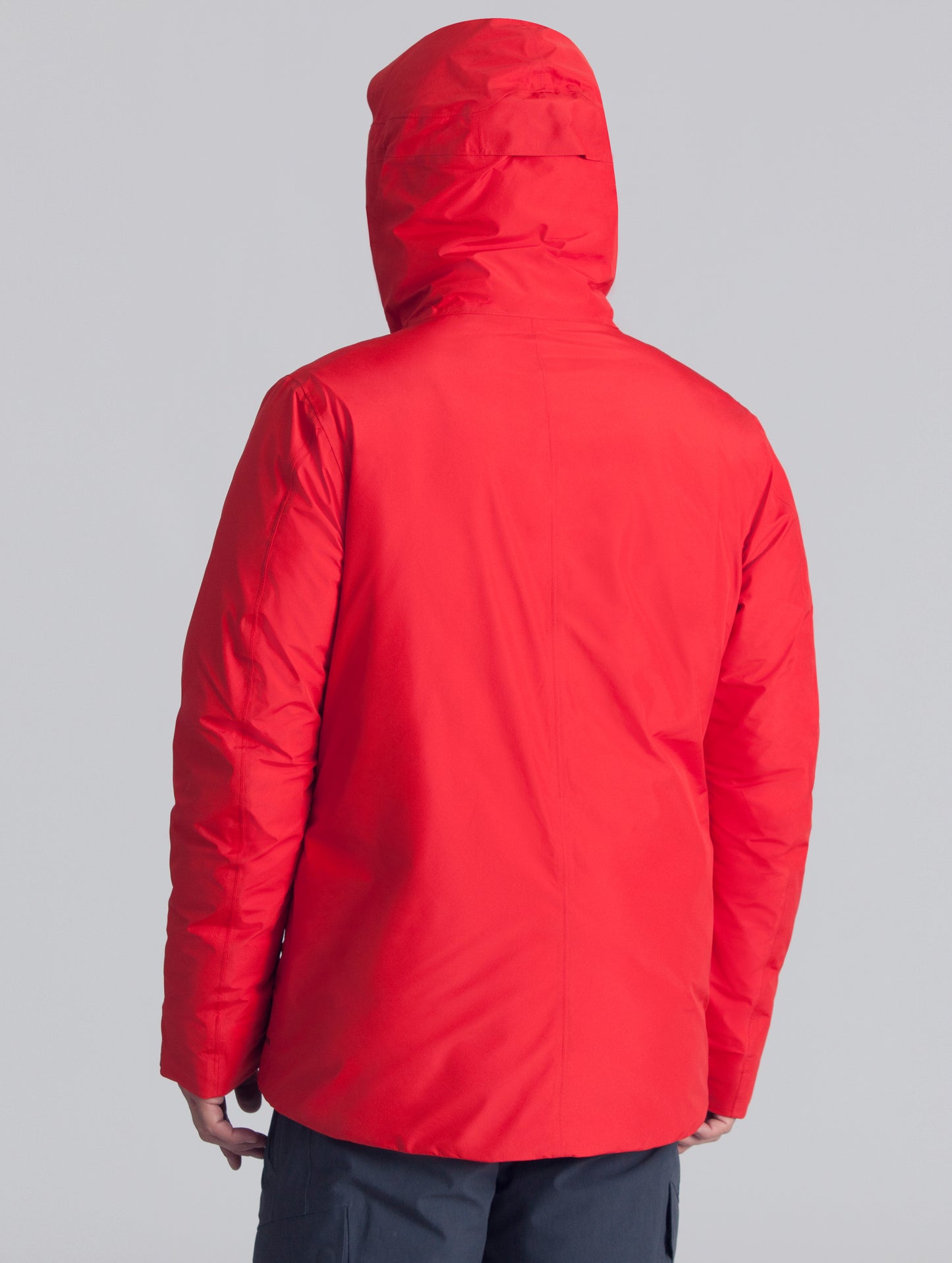 Back view of man wearing red Crest Down Jacket from AETHER Apparel.