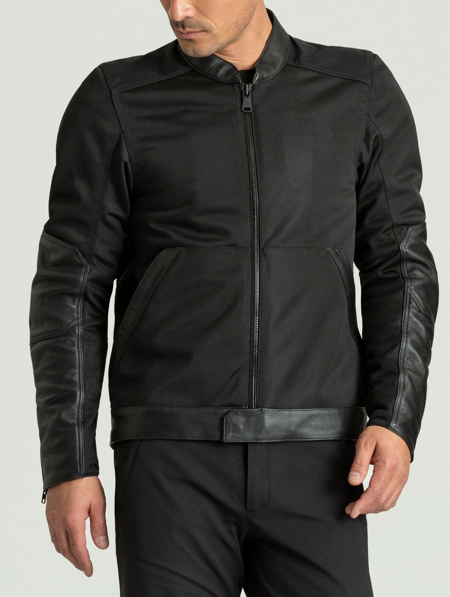 Front body view of man wearing Draft Mesh Motorcycle Jacket in Jet Black from AETHER Apparel.