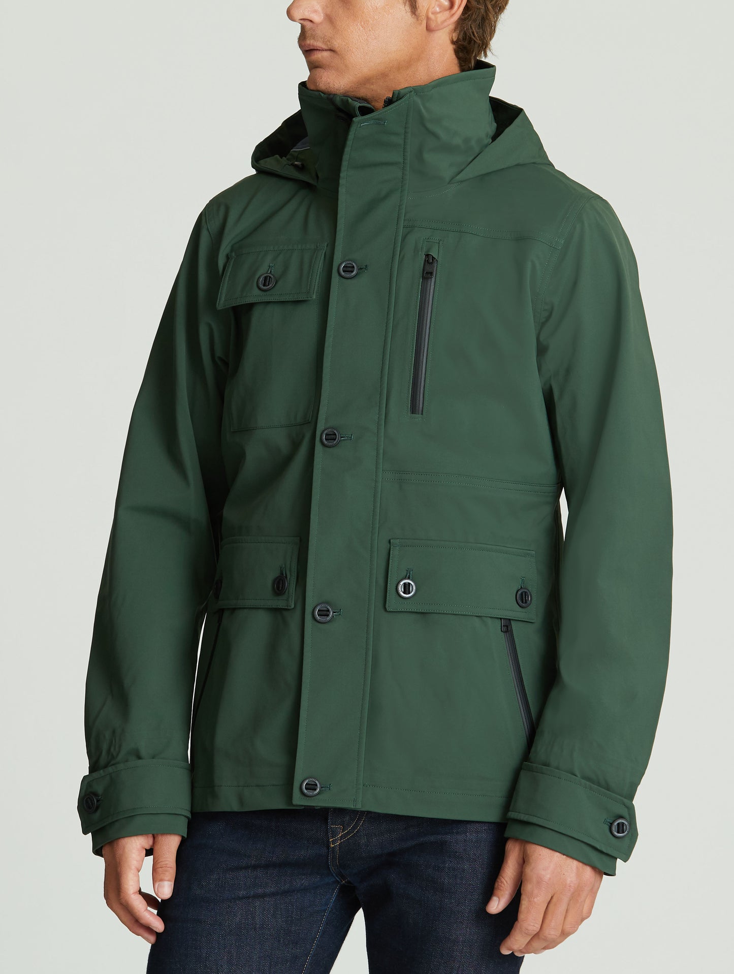 Front 3/4 body view of man wearing Endeavor Jacket in Duffle Green from AETHER Apparel.