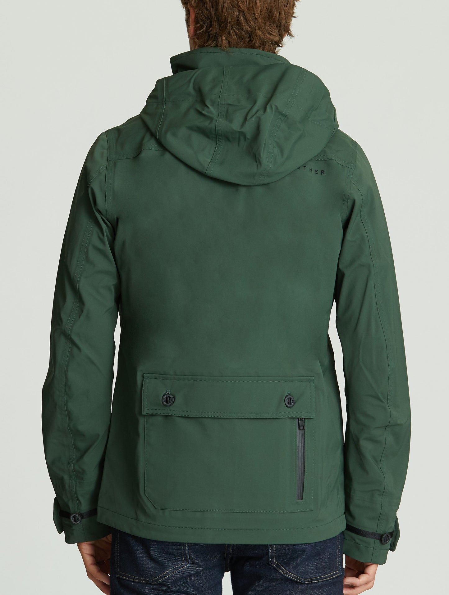 Rear body view of man wearing Endeavor Jacket in Duffle Green from AETHER Apparel.