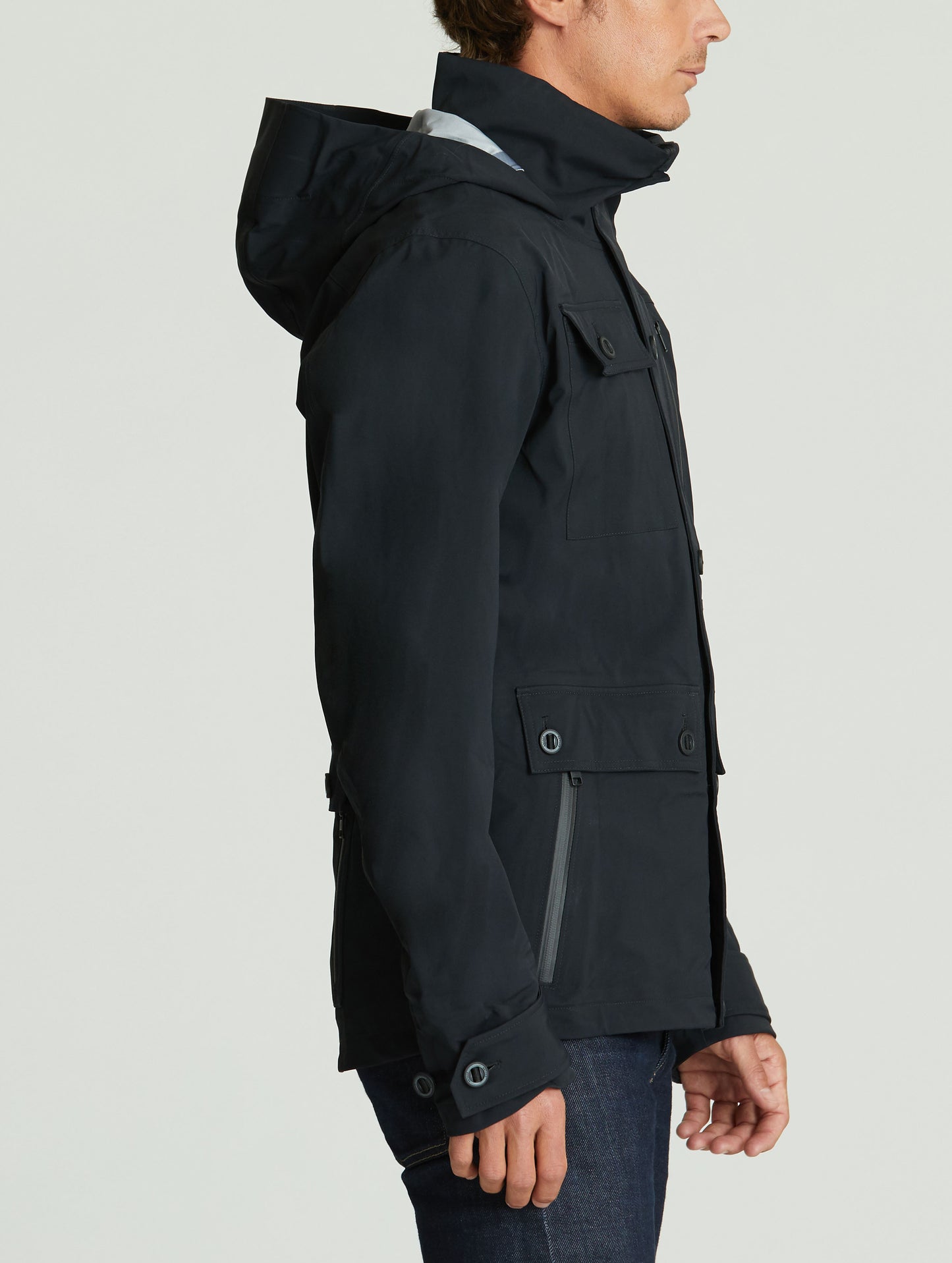 Side profile body view of man wearing Endeavor Jacket in Onyx Black from AETHER Apparel.